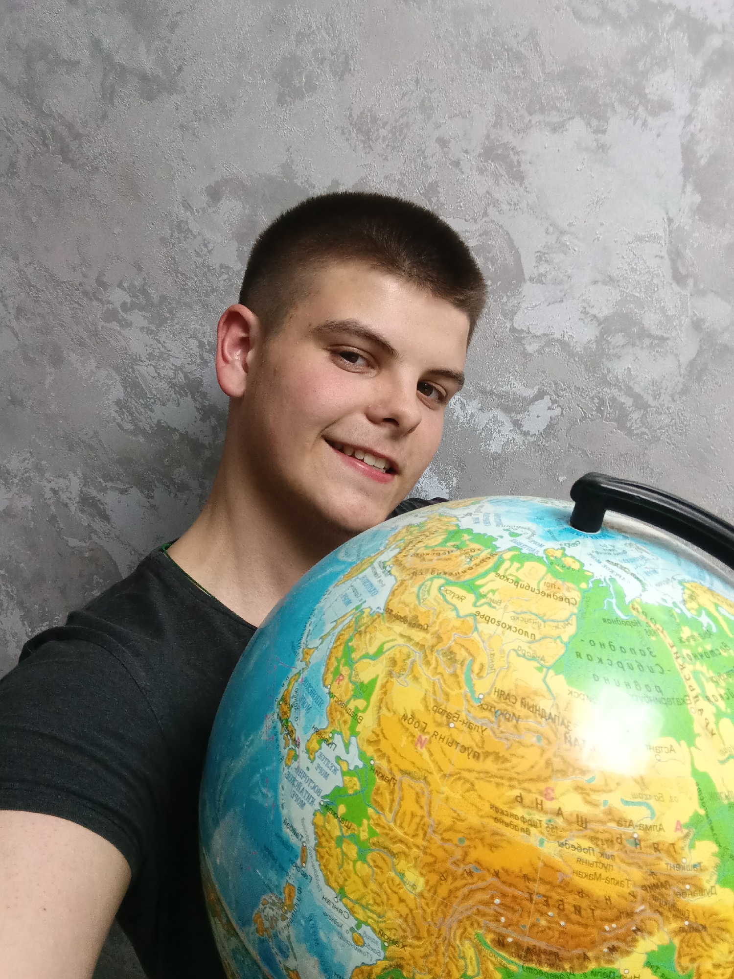 Young man documents personal belongings in Andreyevo home