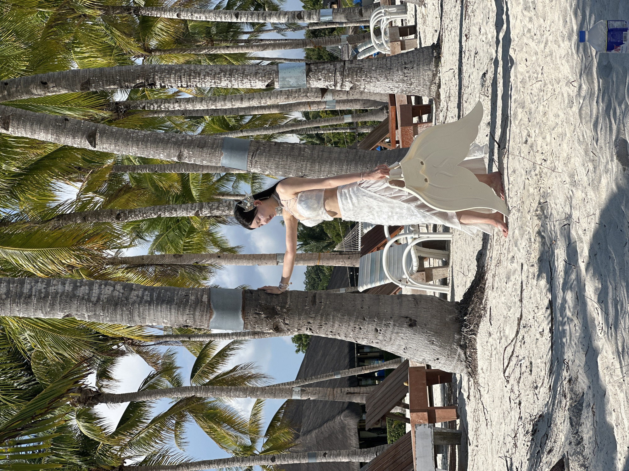 Ornate white beaded outfit on a Panglao beach palm