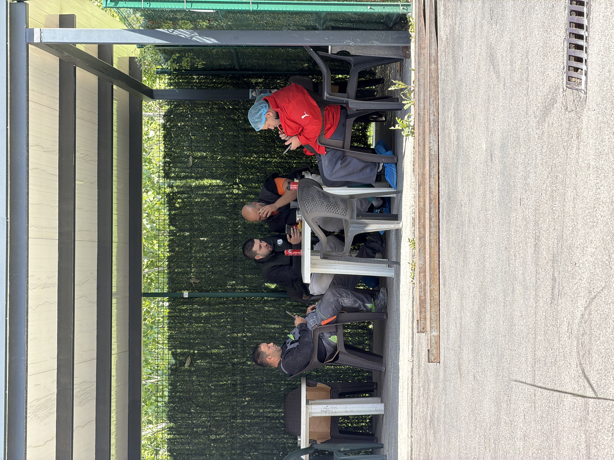 Four people gather at outdoor tables in Lozen, Bulgaria