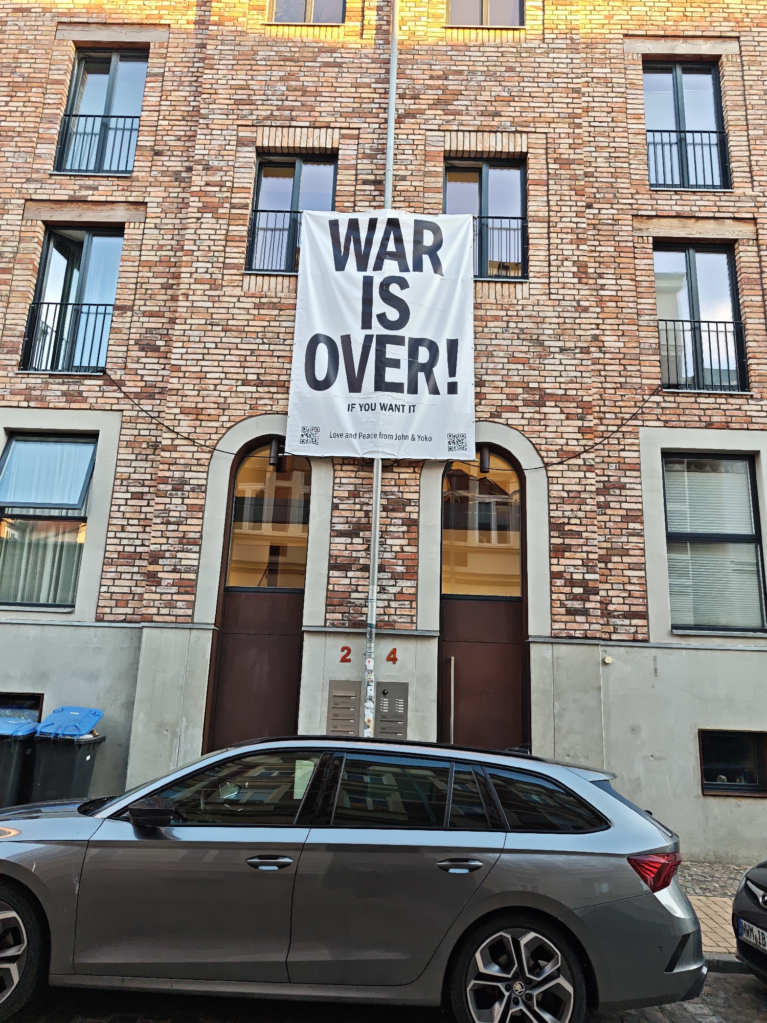 Peace banner and roses on a Schwerin cobblestone street