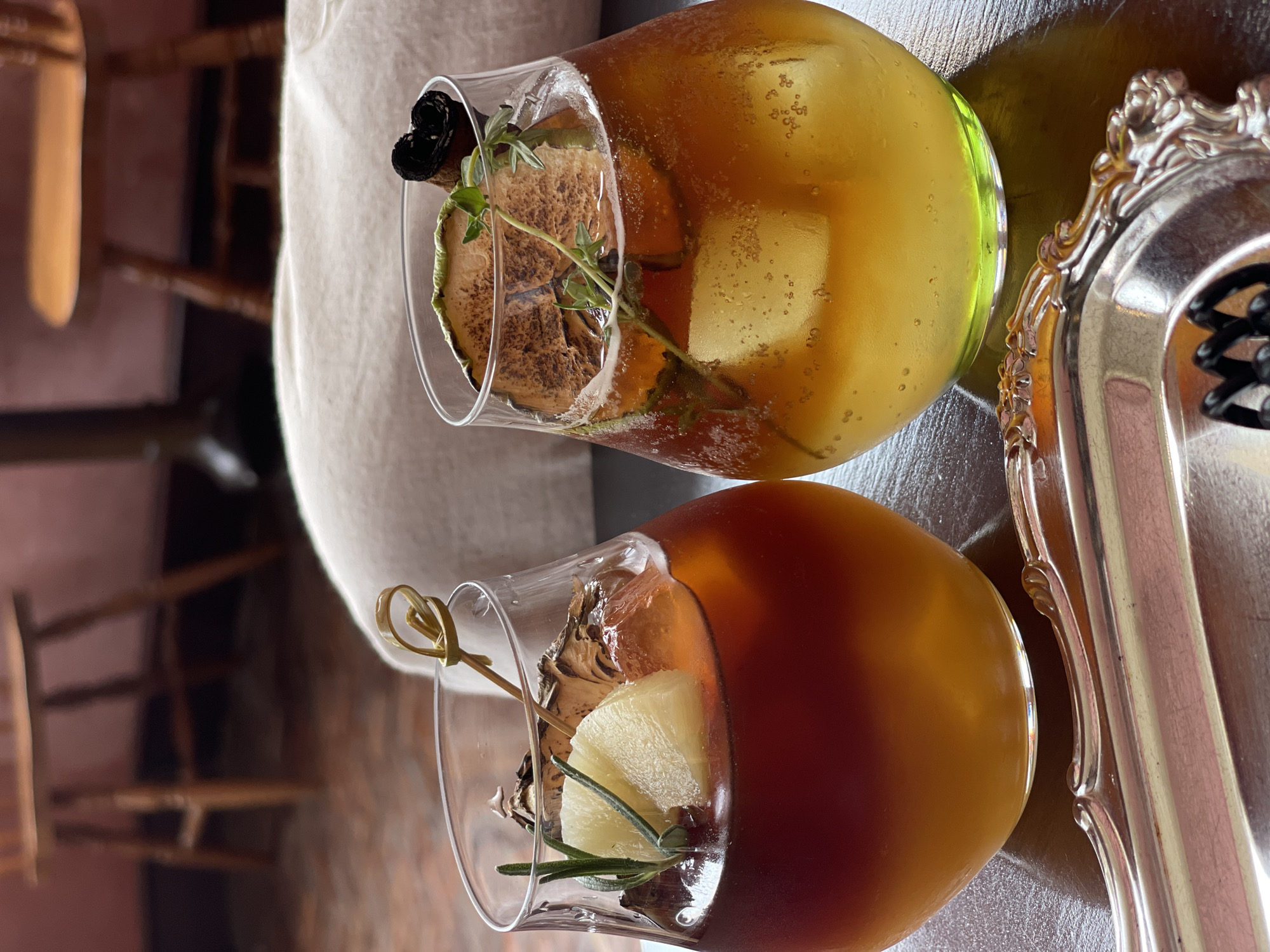 Drinks and a table set inside a atmospheric Bangkok interior