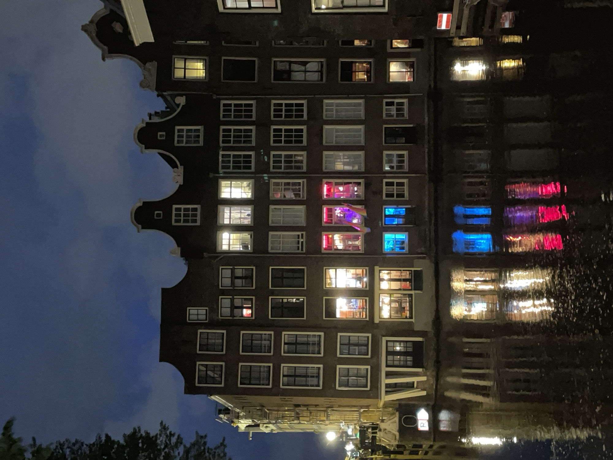 Amsterdam canal houses documented in nighttime scene