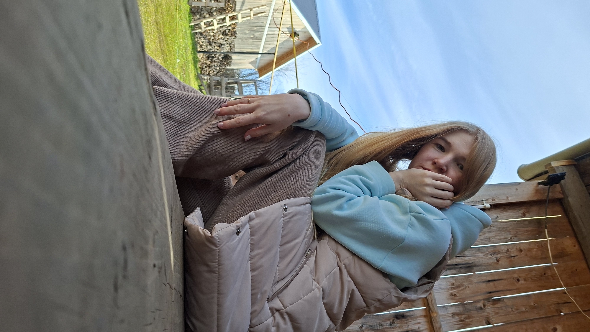 Woman poses for casual photo session in Russian village