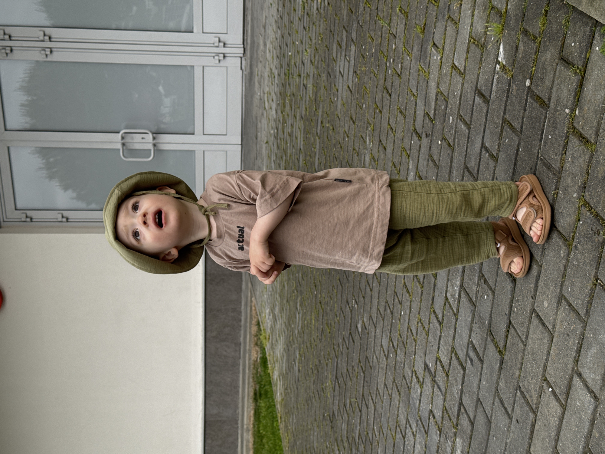 Child looks skyward on walkway in Sirius, Russia