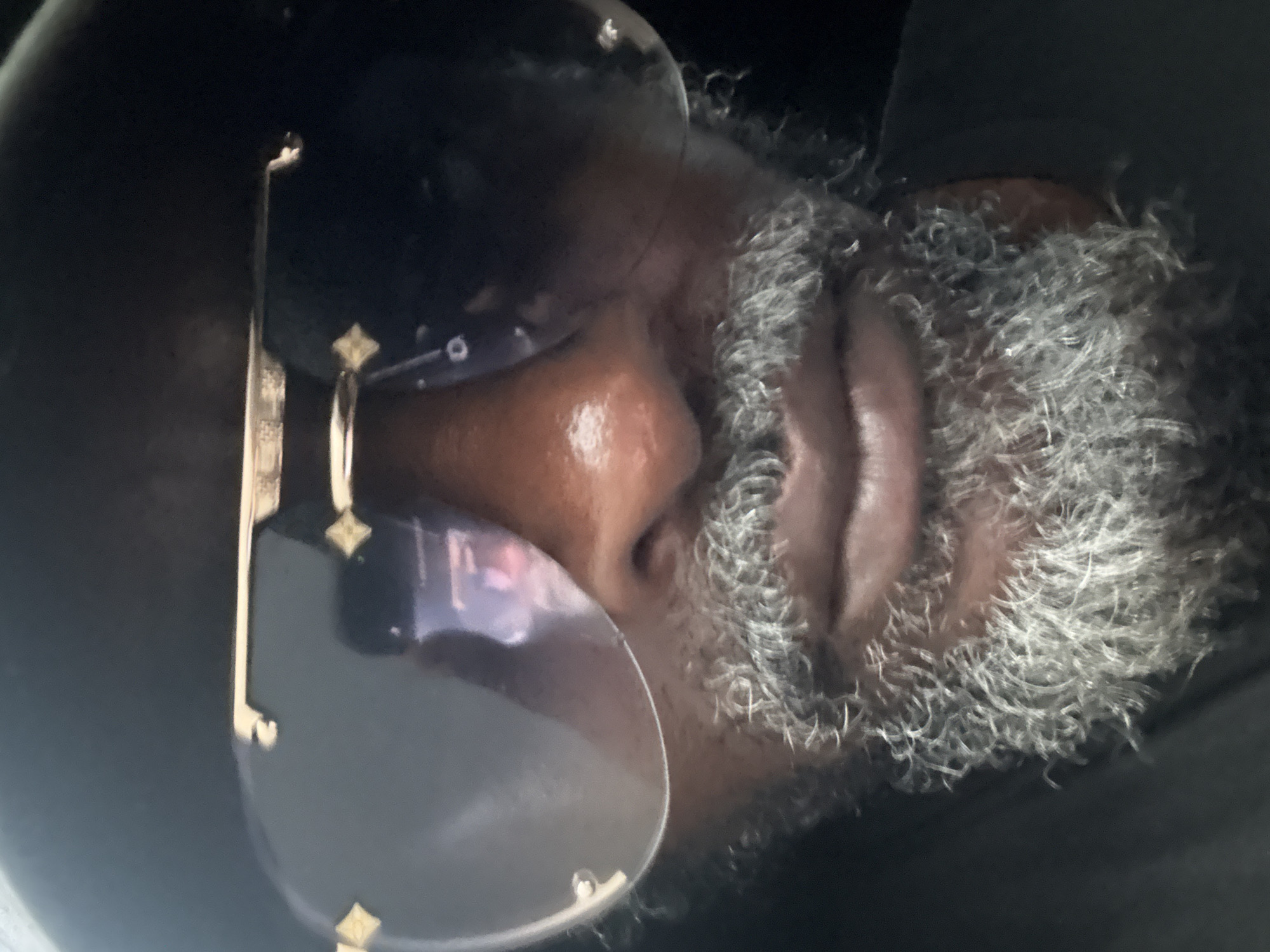 Close-up portrait detail, gold-accent sunglasses, Ado Nigeria
