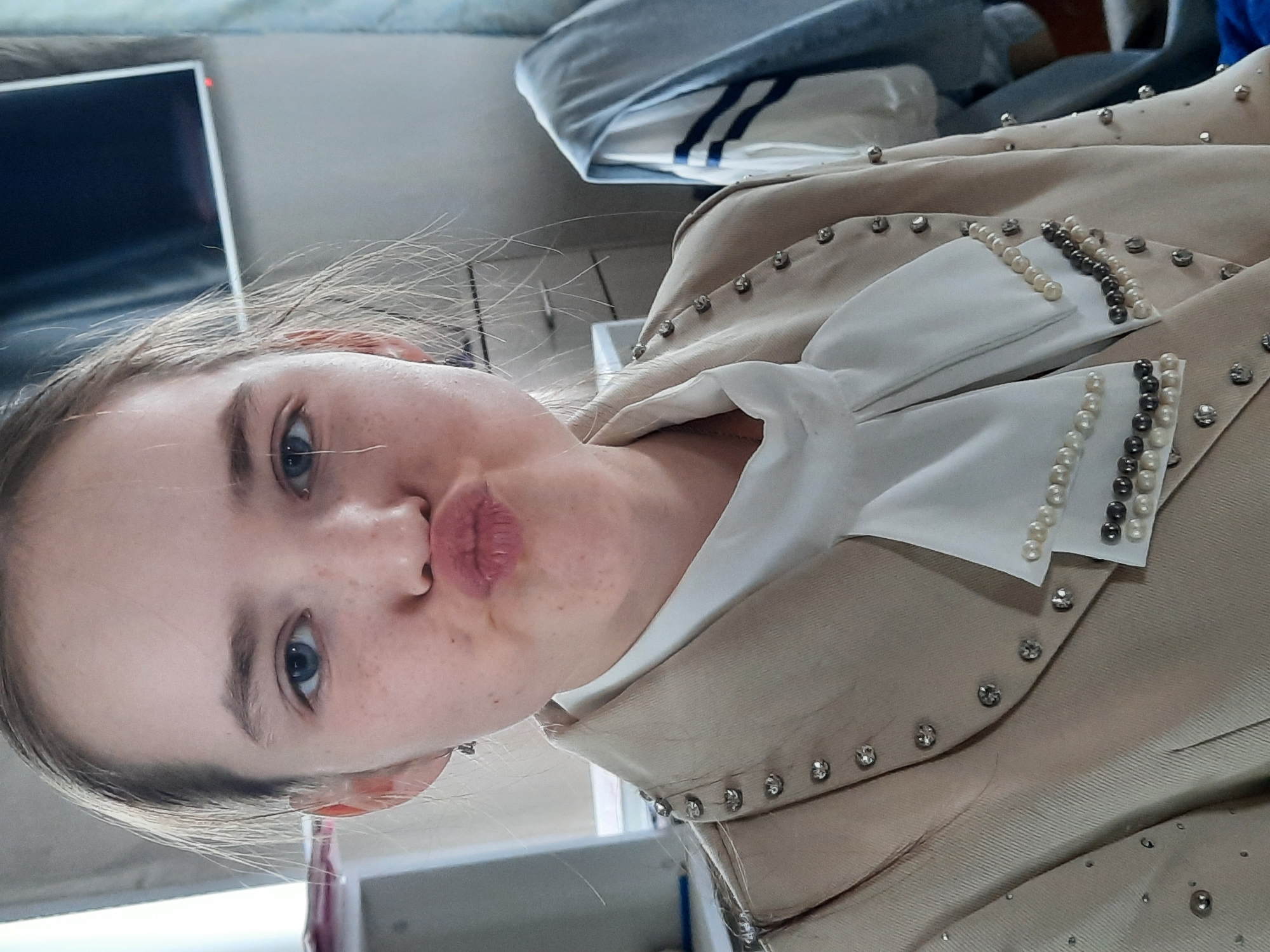 Person in decorative beige jacket photographed in Krasnogorskoye, Russia