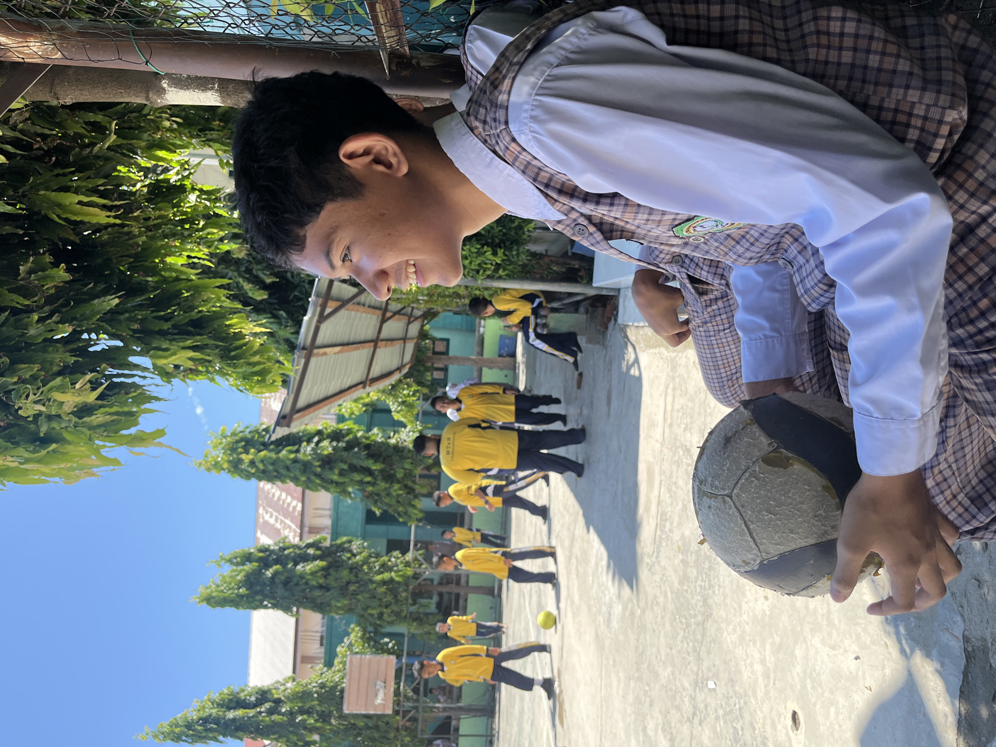 Kids with soccer balls on a school court in Lhokseumawe