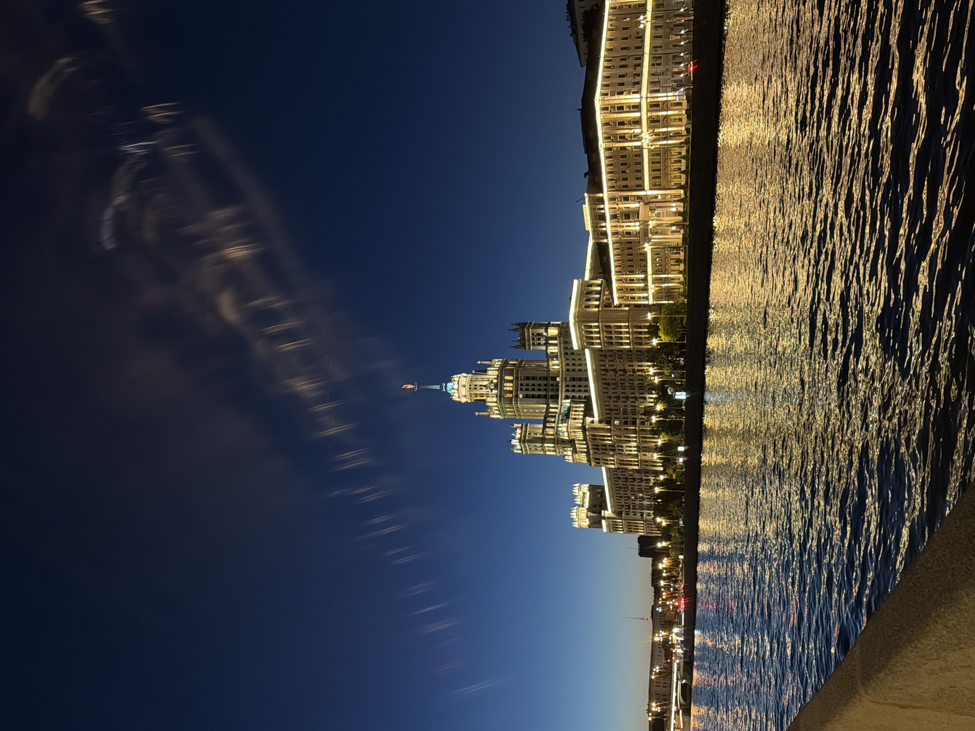 Moscow's Kotelnicheskaya skyscraper glows over the Moskva River at night