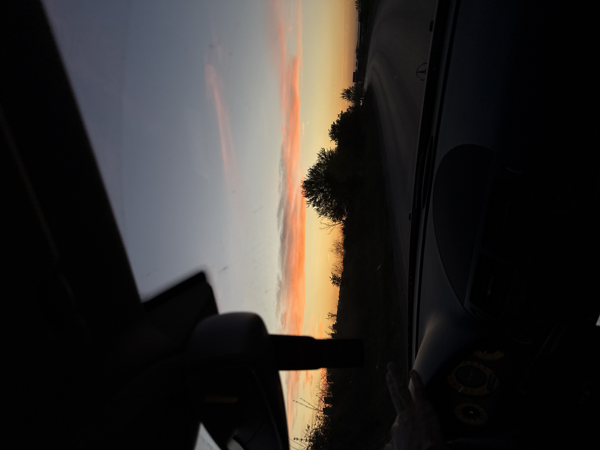 Woman rests in vehicle during sunset in Sofia