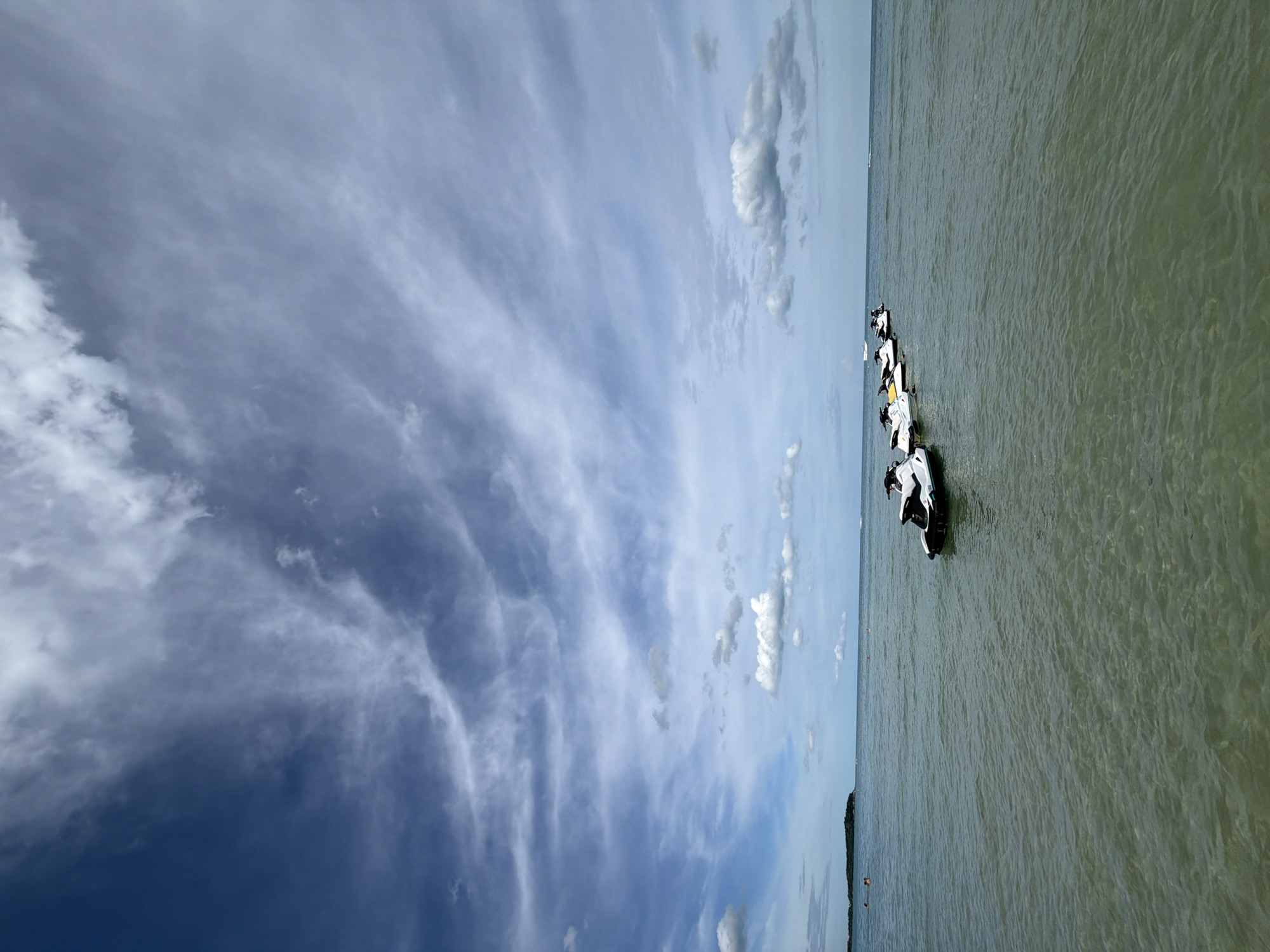 Jet skis lined up at Chaweng Beach on a cloudy morning