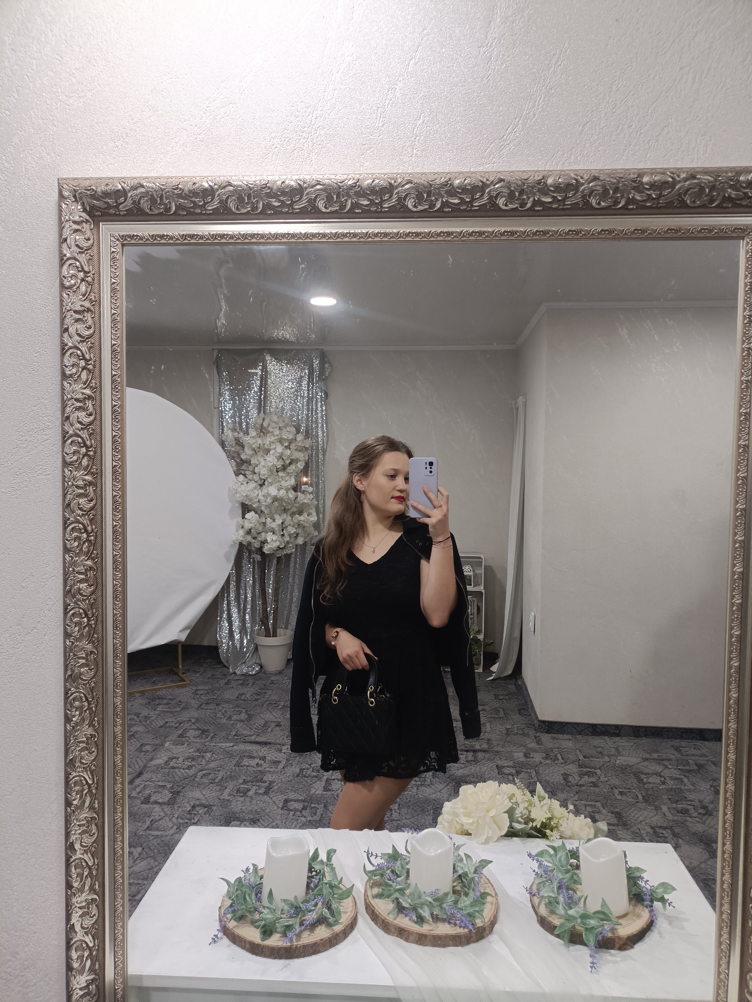 Woman takes mirror selfies at decorated event venue in Plovdiv