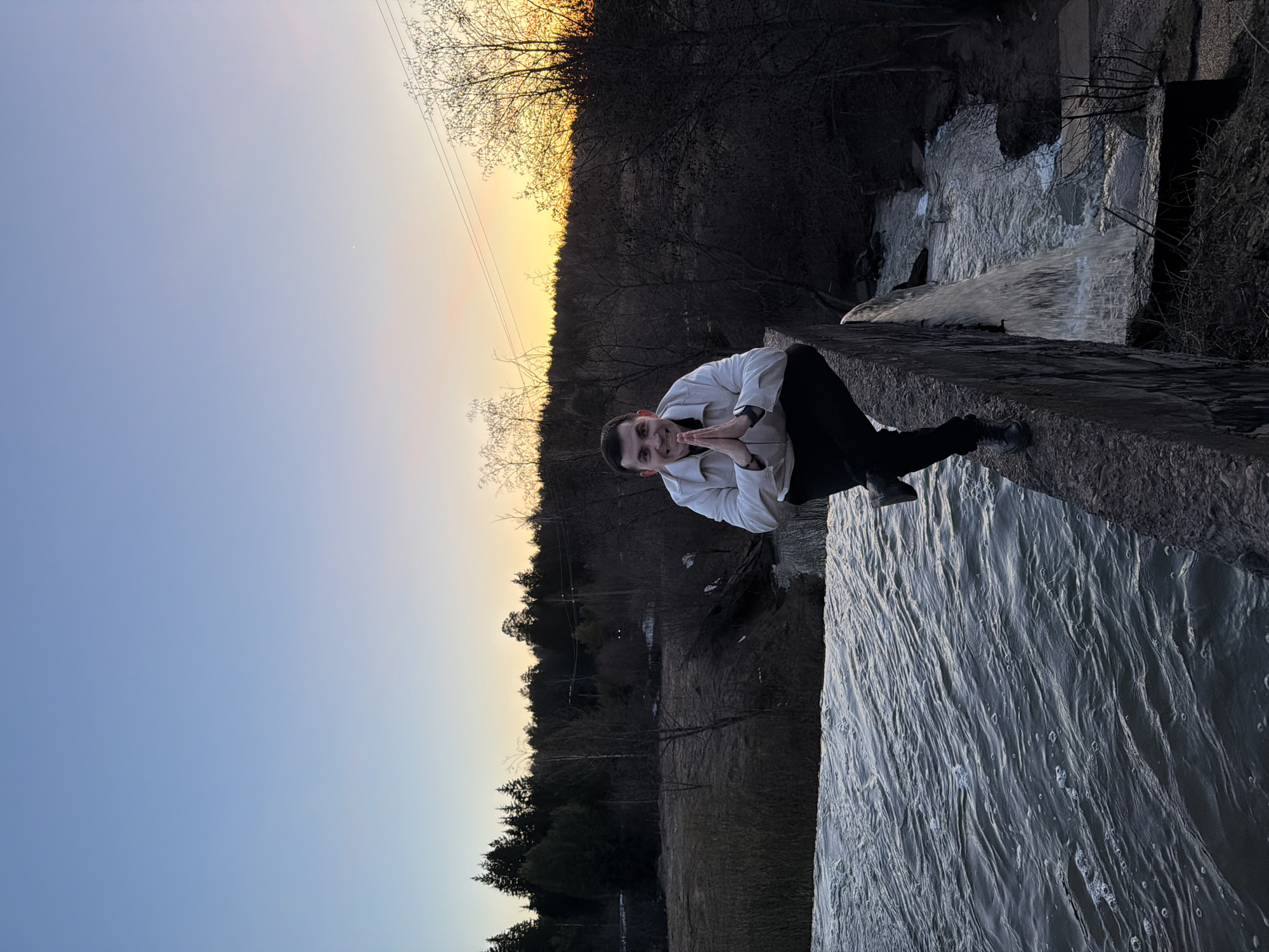 Young man photographed on stone wall in Kamennoye, Russia