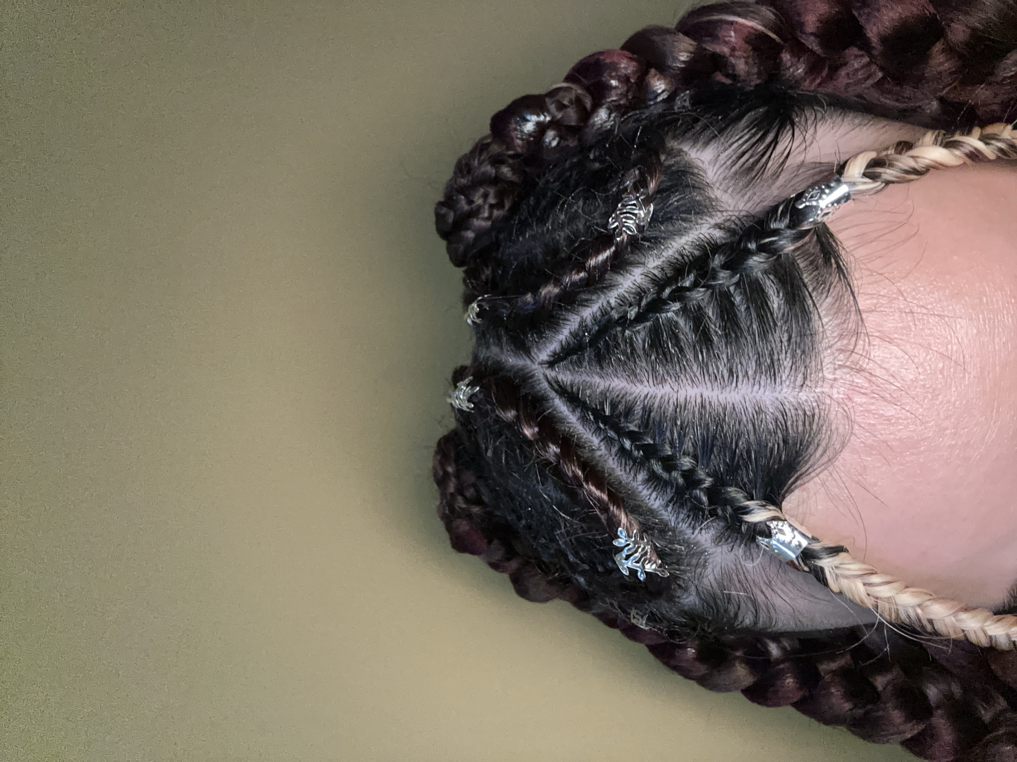 Elaborate braided hairstyle with silver charms spotted in Sofia