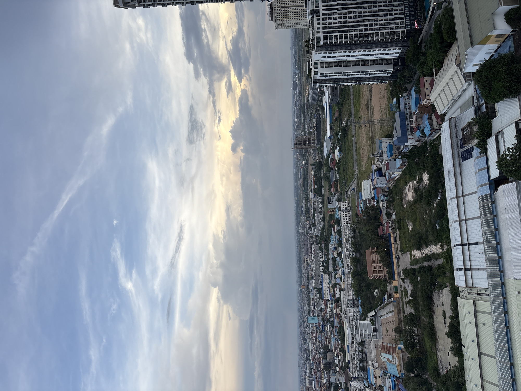 Rooftop pool views over Khan Mean Chey at golden hour
