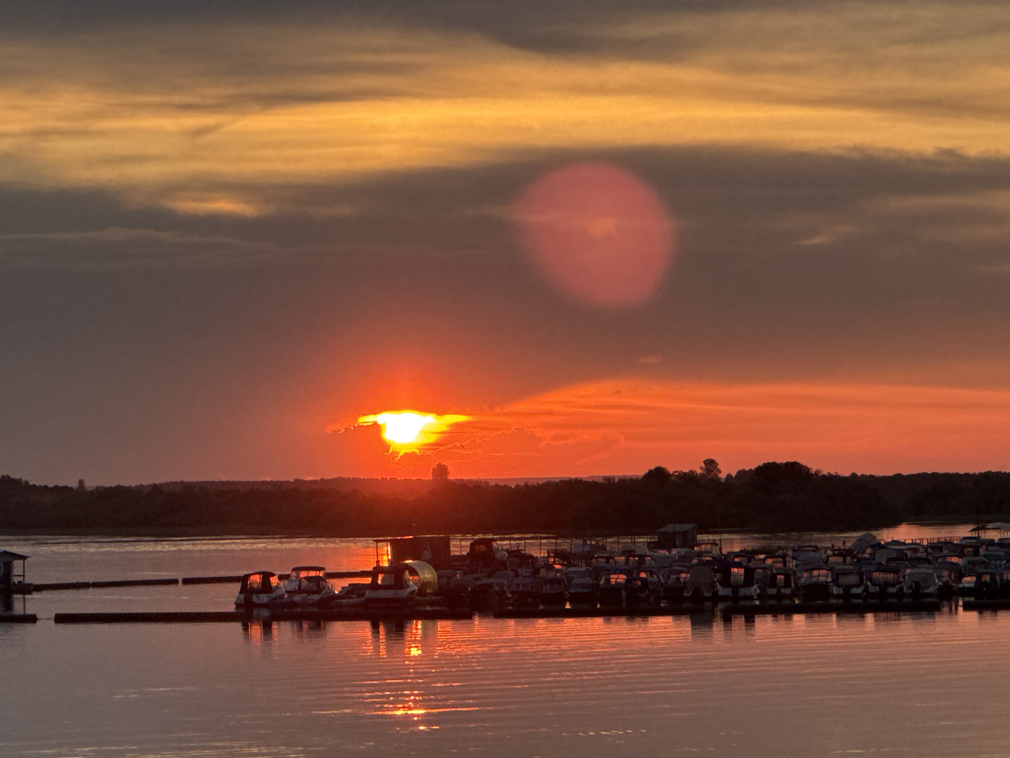 Vibrant sunset over Solikamsk waterfront draws evening crowds