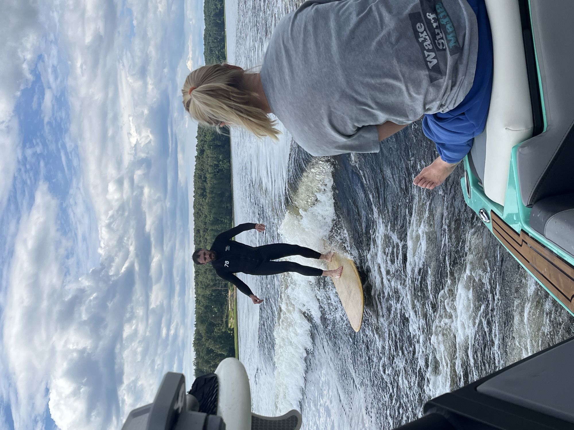 Wake surfing a boat's wave on a Russian lake