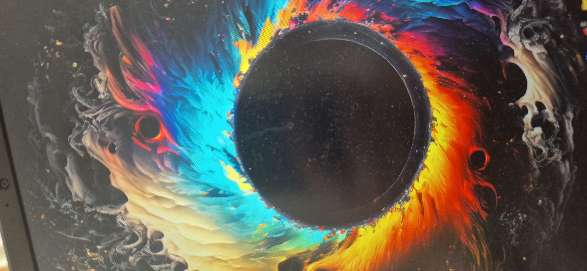 Digital artwork featuring black hole displayed on laptop screen