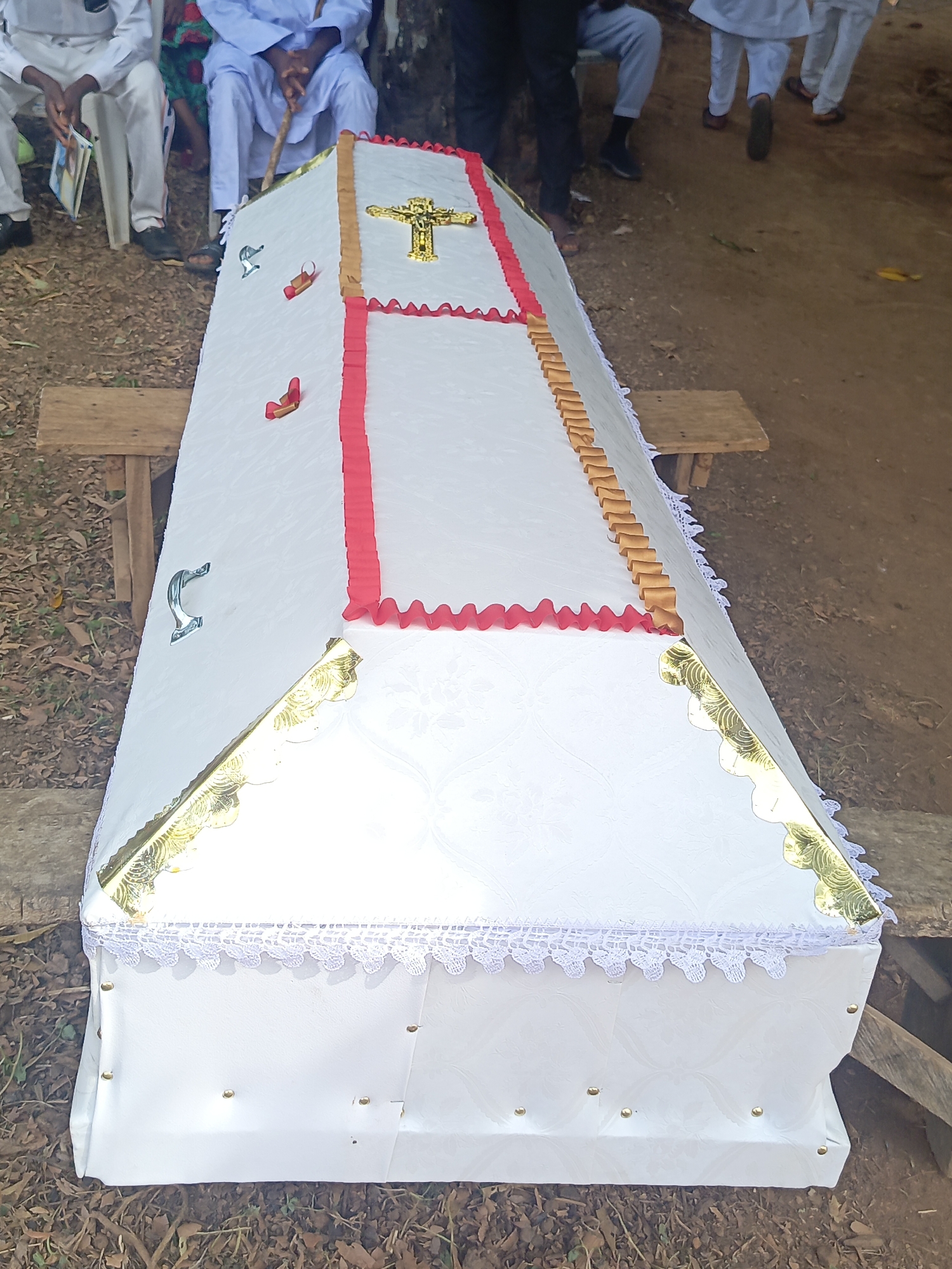 Outdoor funeral service held in Andaha, Nigeria with white-clad attendees