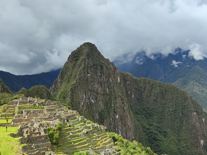 Tourists explore and photograph Machu Picchu ruins in Peru