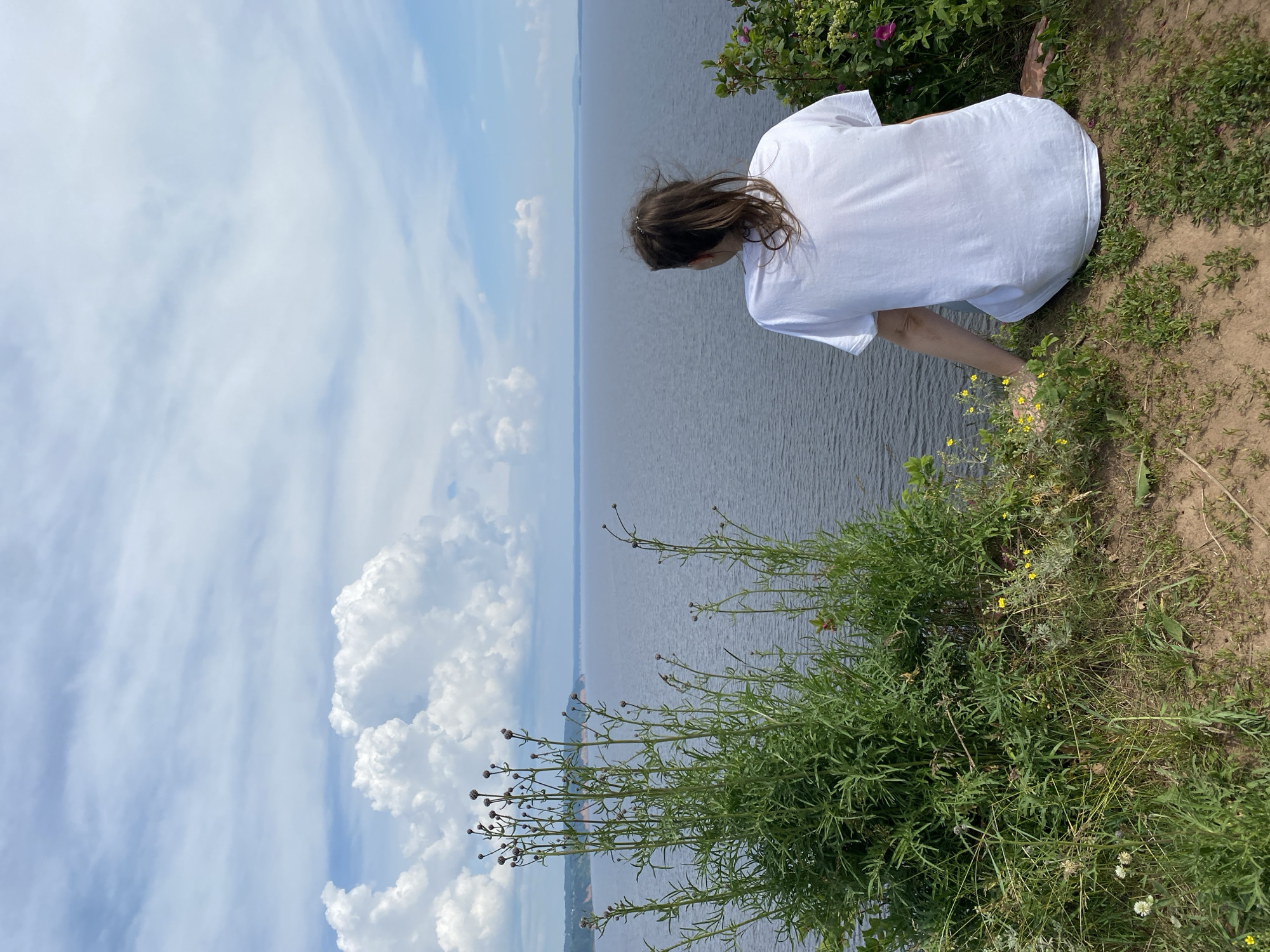 Clifftop river views and wooden town signage in Kostovaty