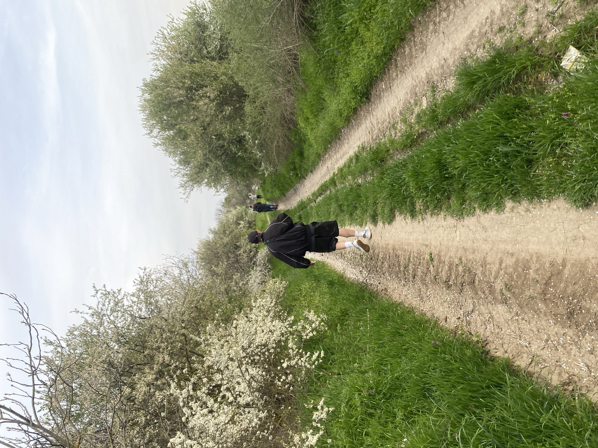 Two walkers traverse rural path in Vetovo, Bulgaria