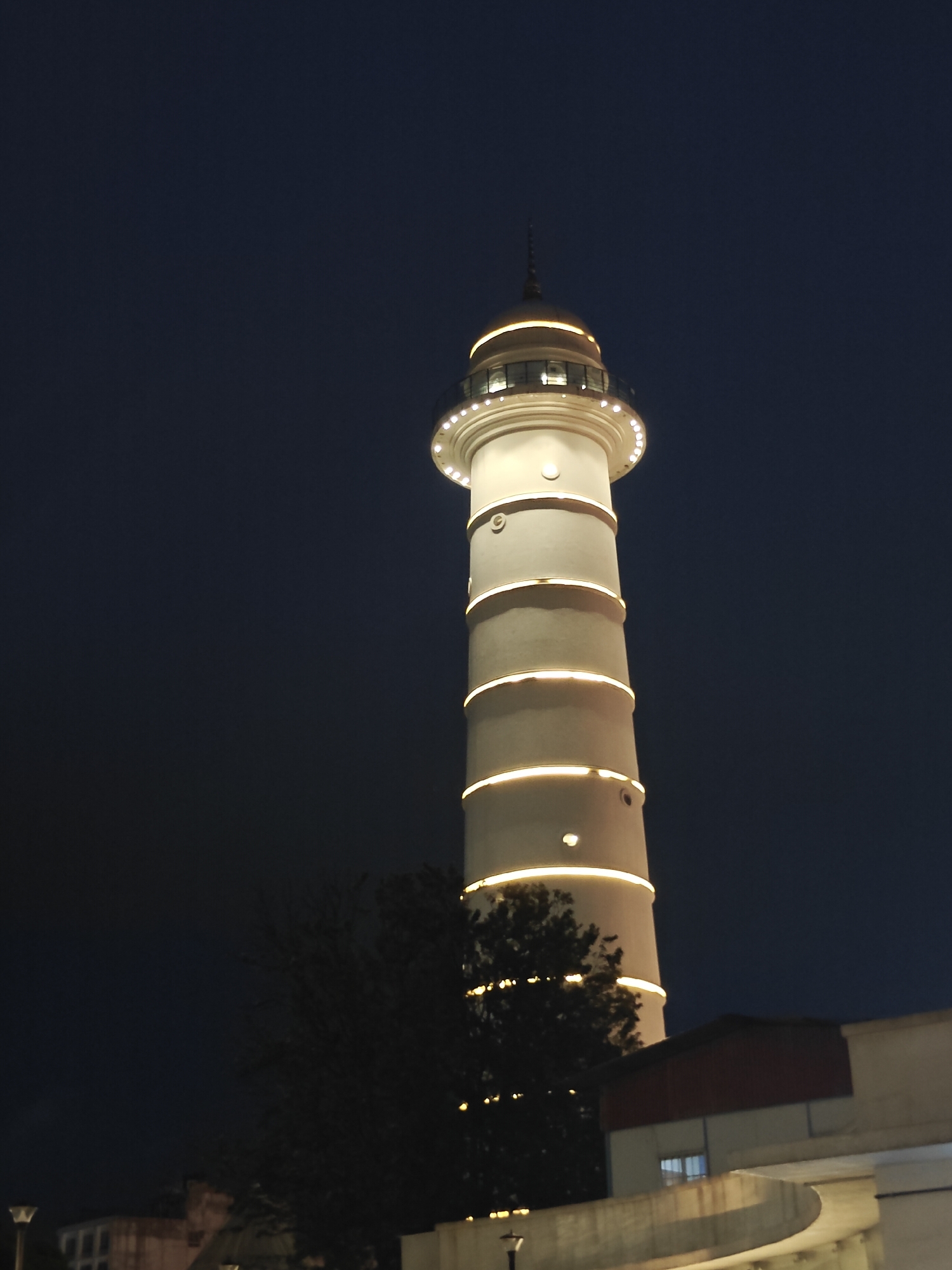 Lit-up tower and Kathmandu streetscapes after dark