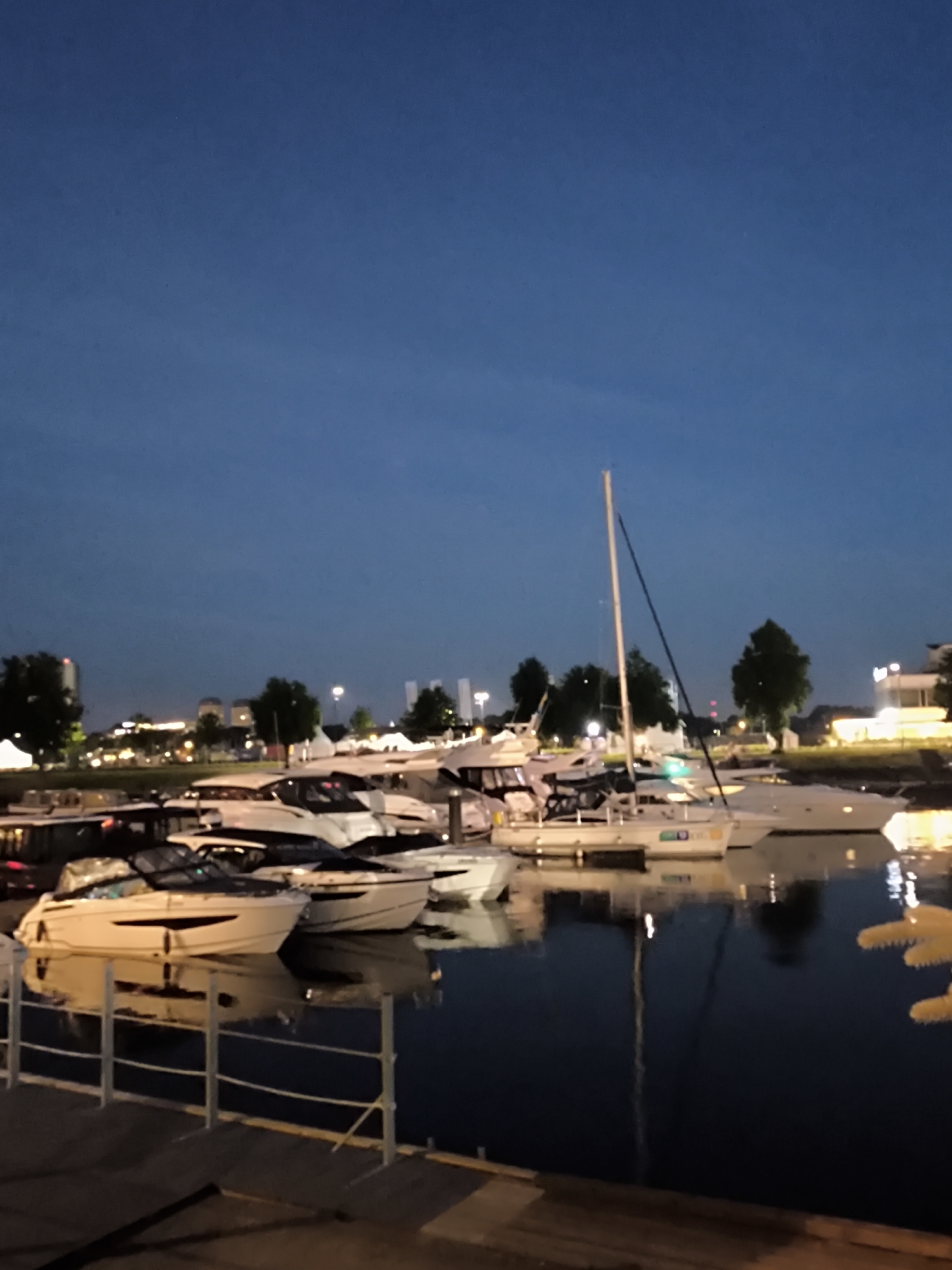 Riga marina at night, boats docked on still water
