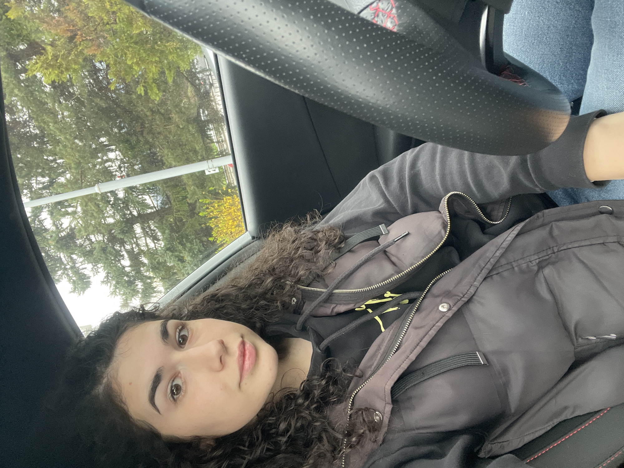 Woman observed resting in passenger seat, Sofia morning