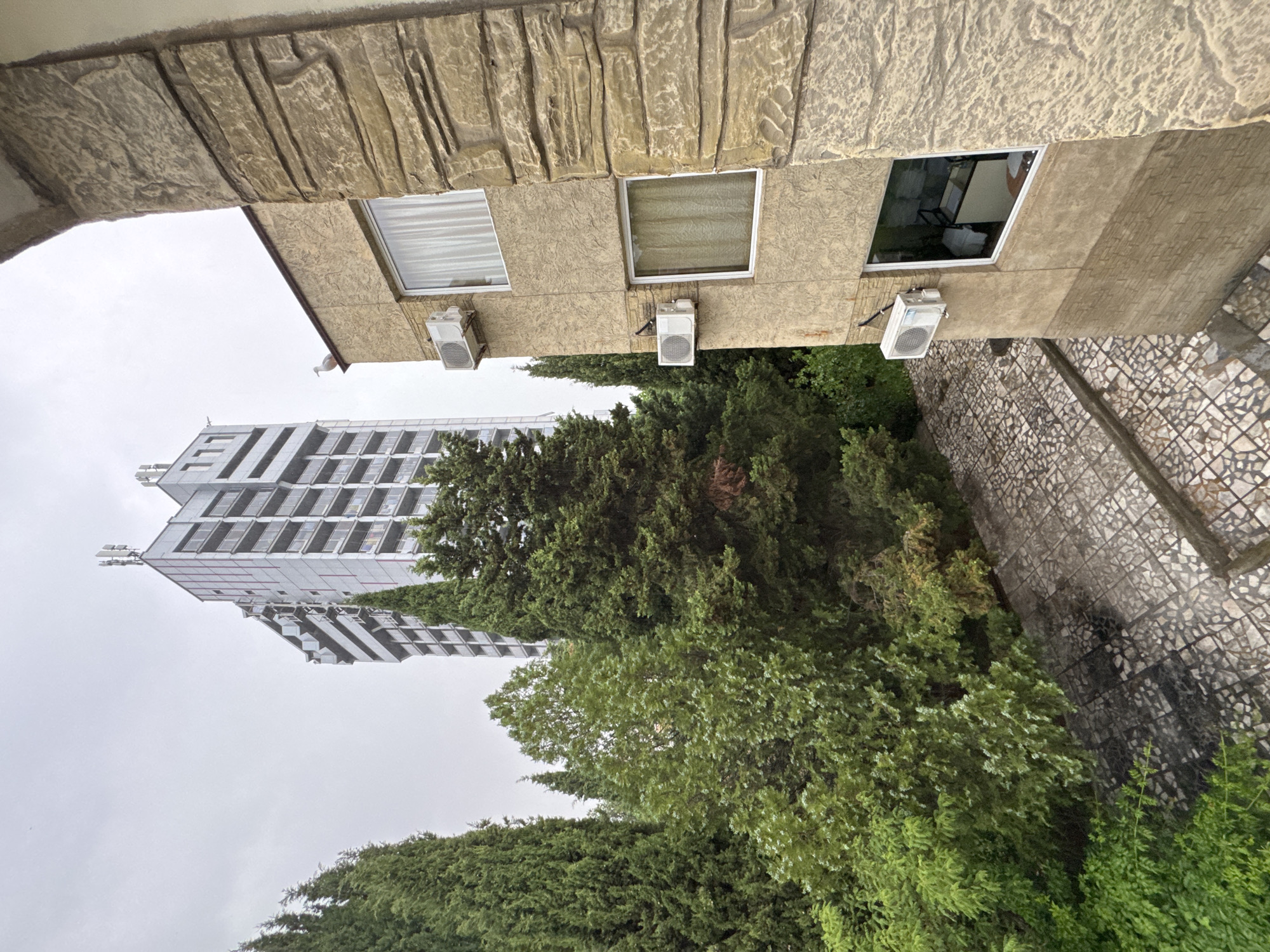 Nesebar residential area: high-rise, trees, and street-level buildings