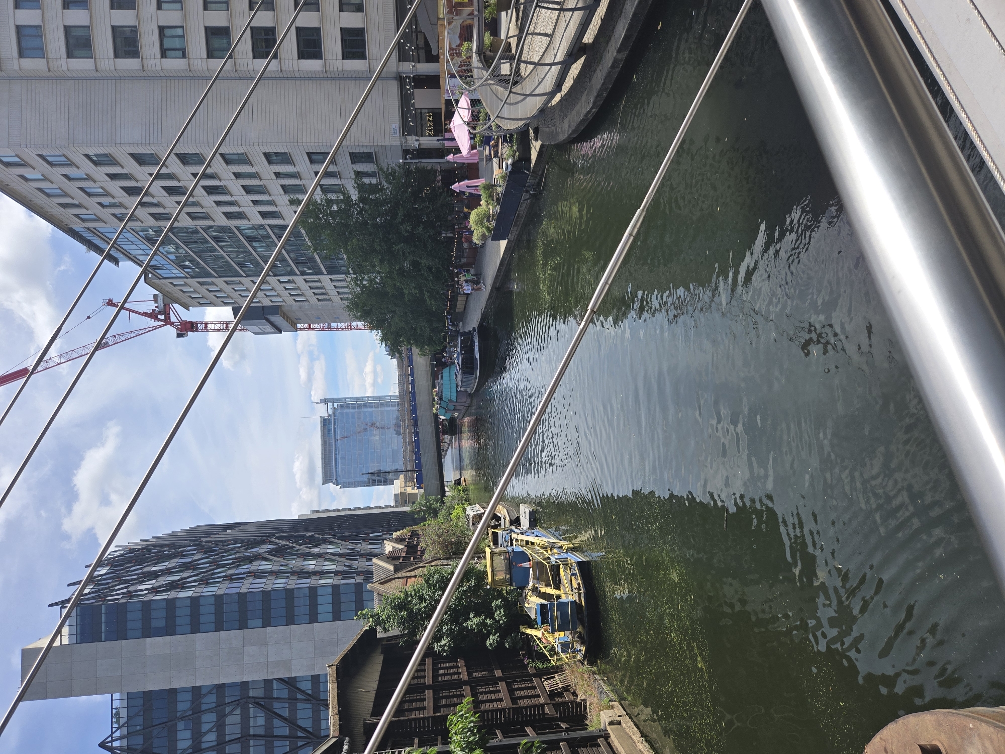 Colorful houseboats and canal life along a sunny London waterway