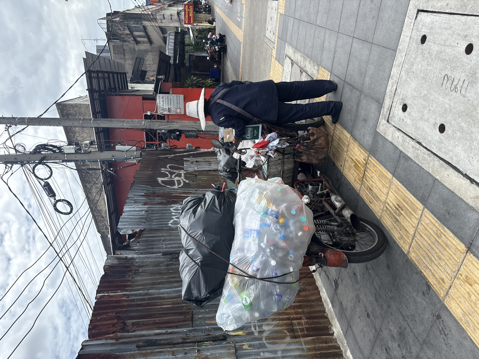Bangkok street life: traffic, back alleys, and a flag on the sidewalk