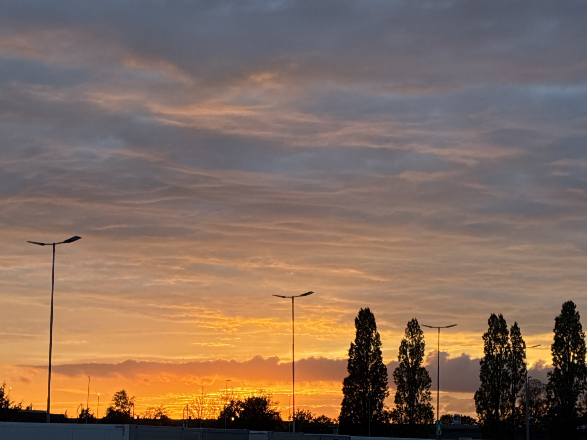 Dramatic dusk sky over an urban skyline at golden hour
