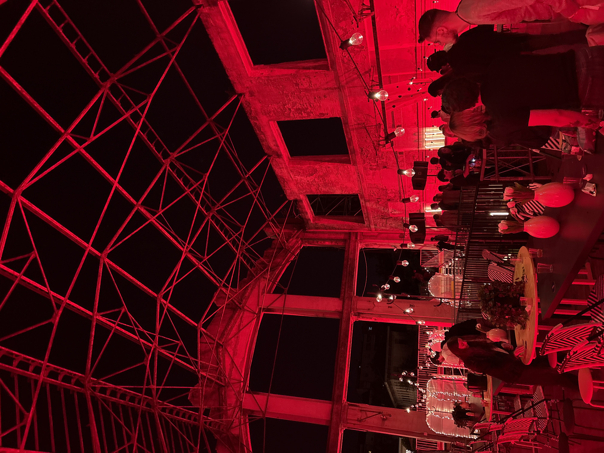 Social gathering at red-lit Milan rooftop bar draws attendees
