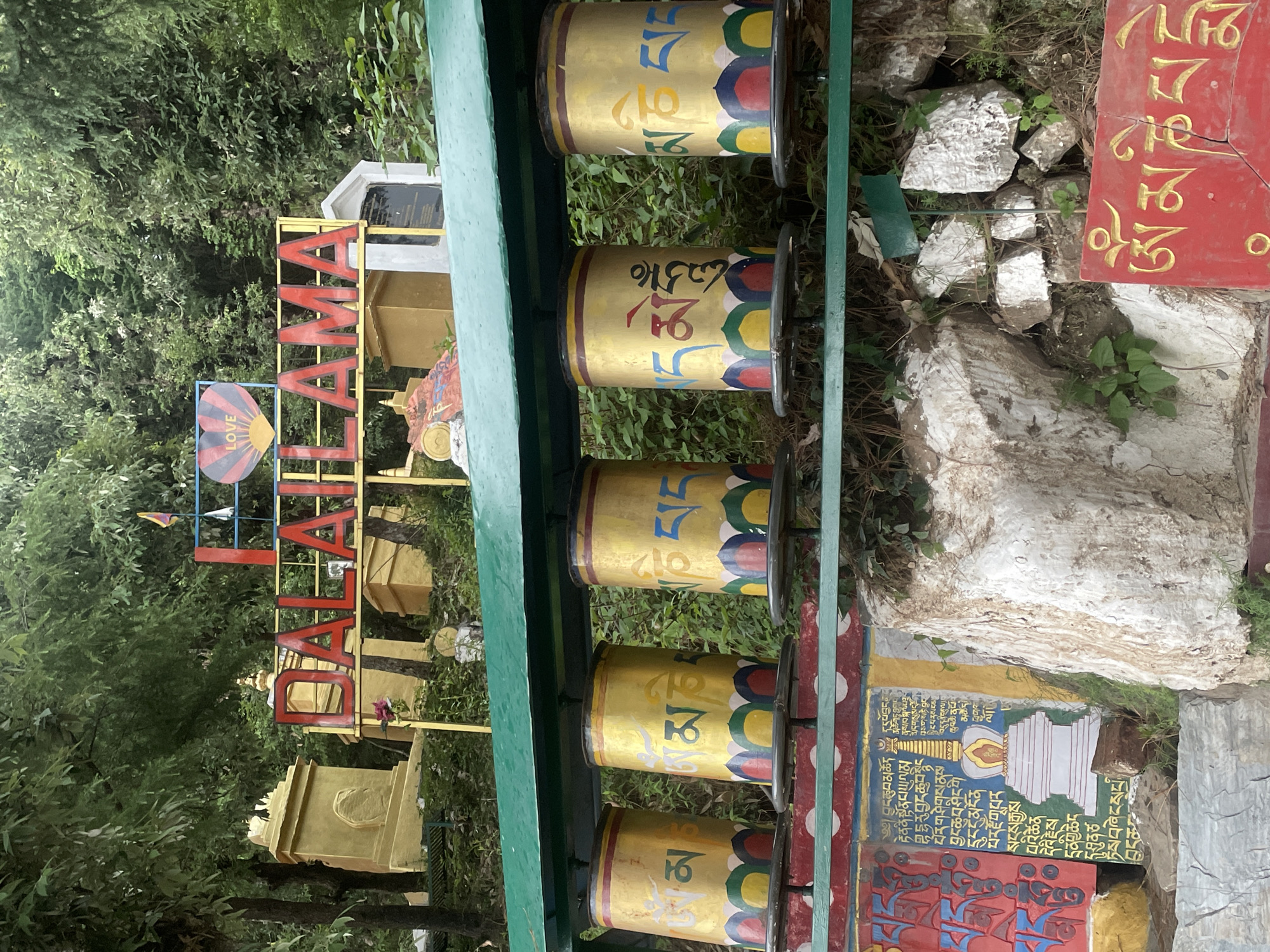 Visitor documents Buddhist prayer wheels and Tibetan flags in Dharamshala