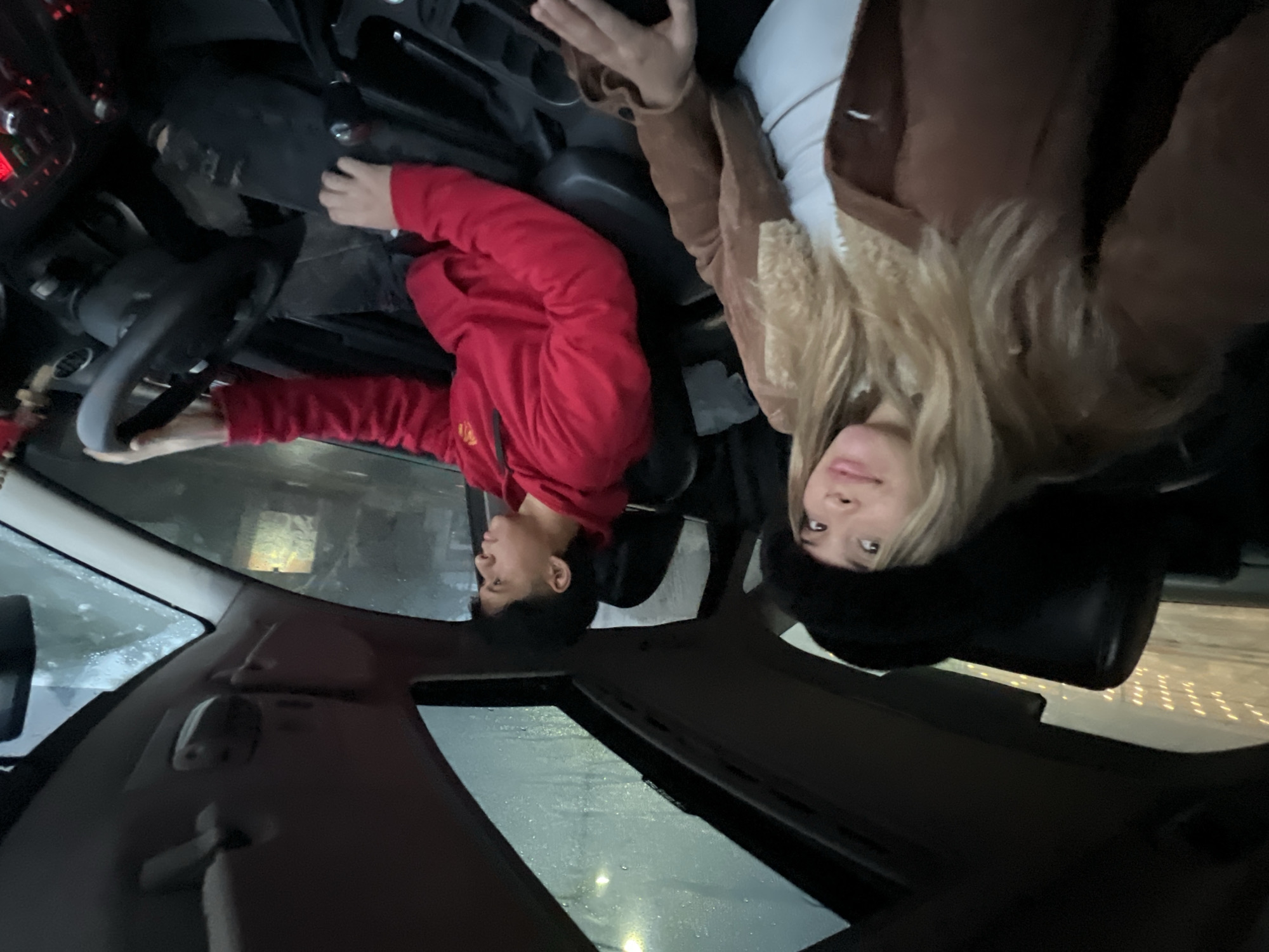 Two people sit in car during rain in Catamarca