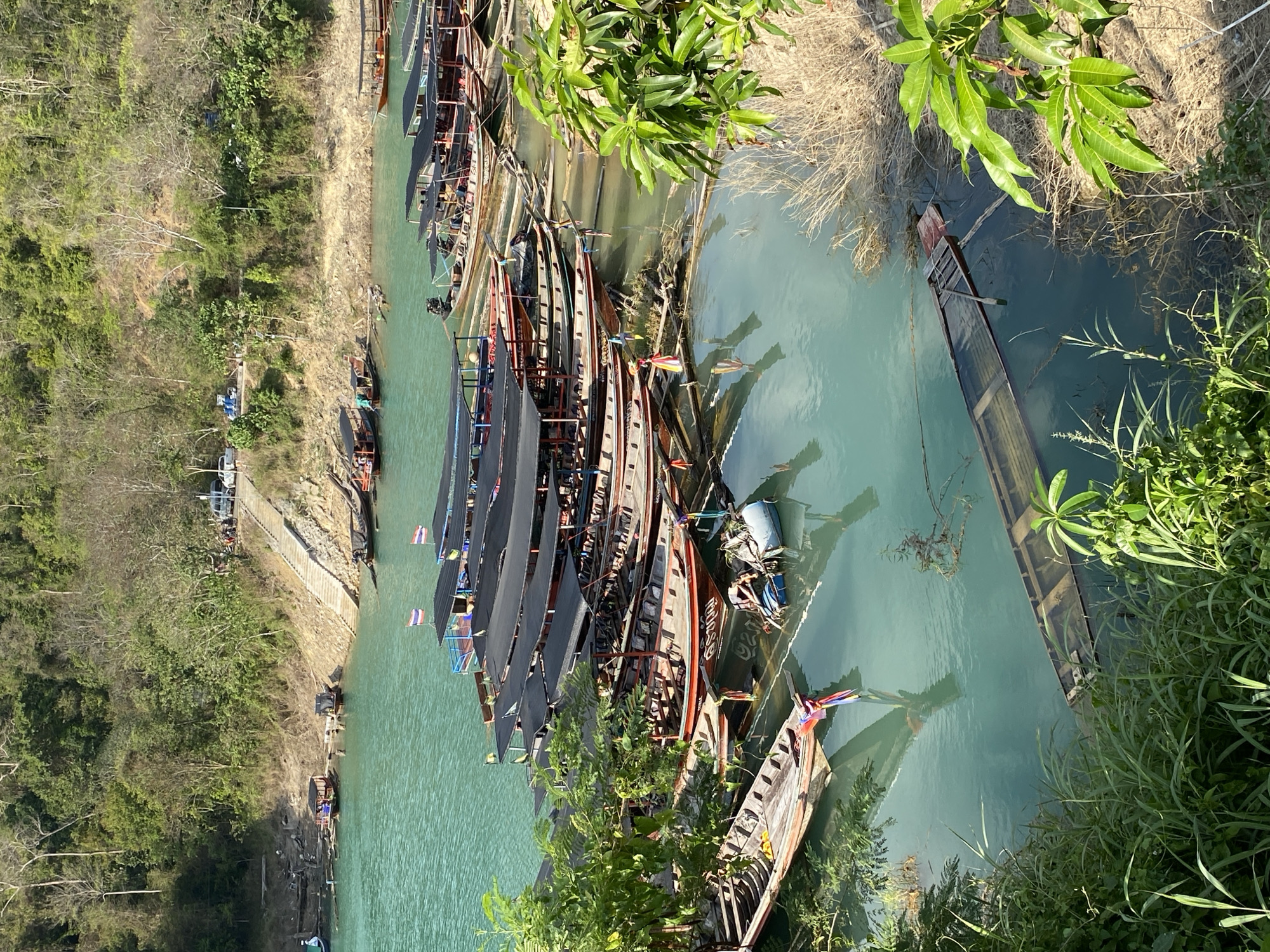 Traditional longtail boats documented at Thai waterways during sunset