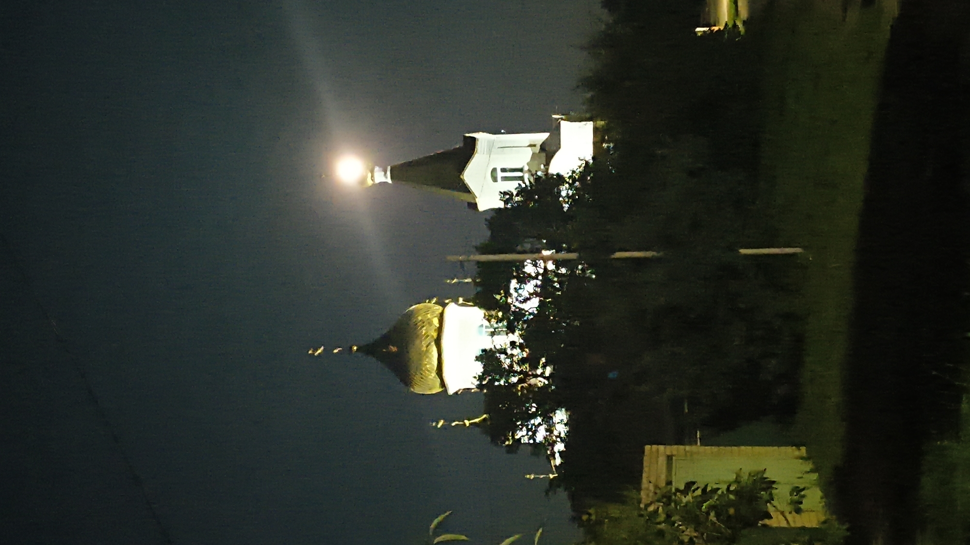 Nighttime streets and lit-up Orthodox churches in Mikhaylovka