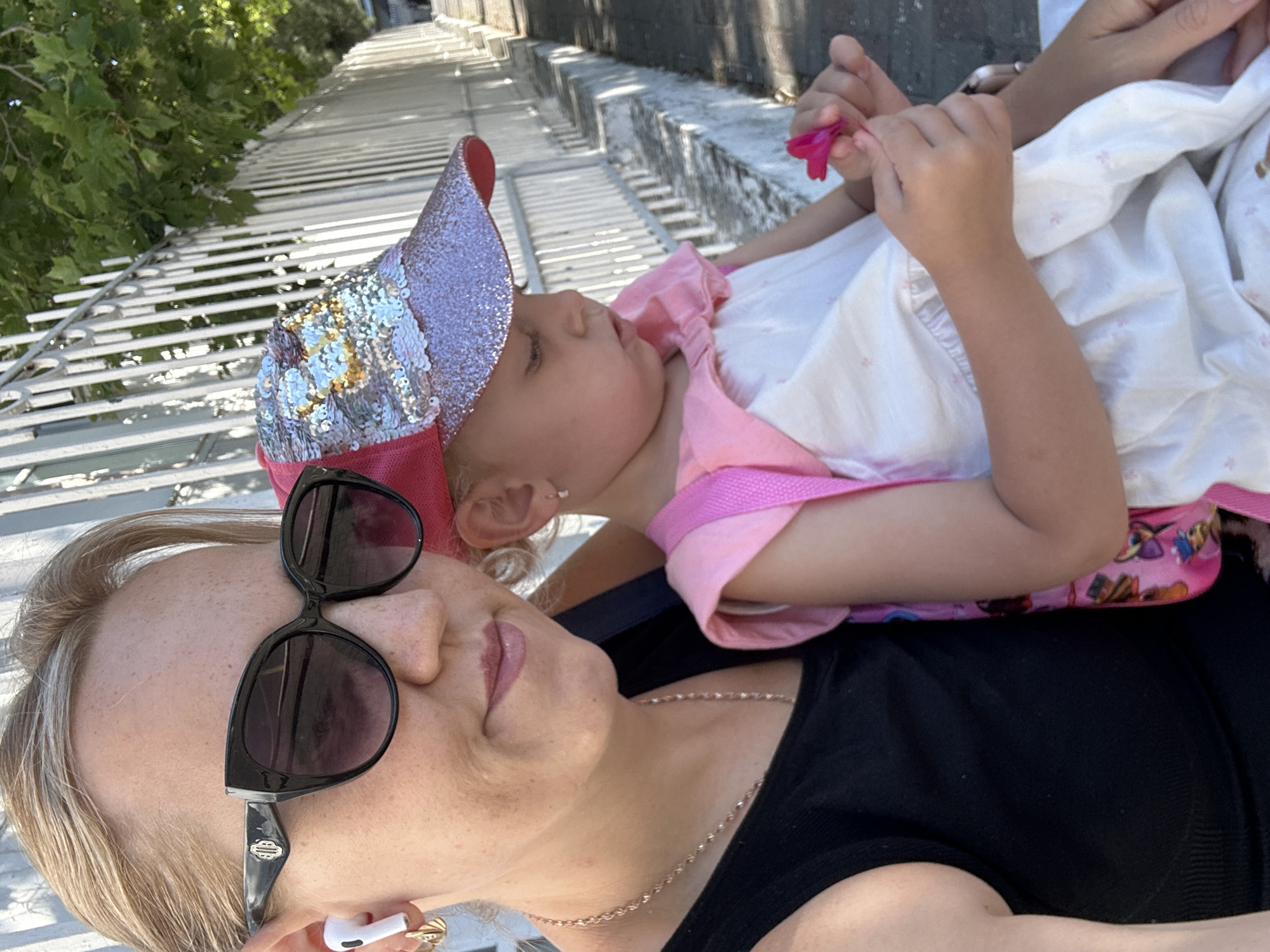 Holding a child outdoors in an urban setting