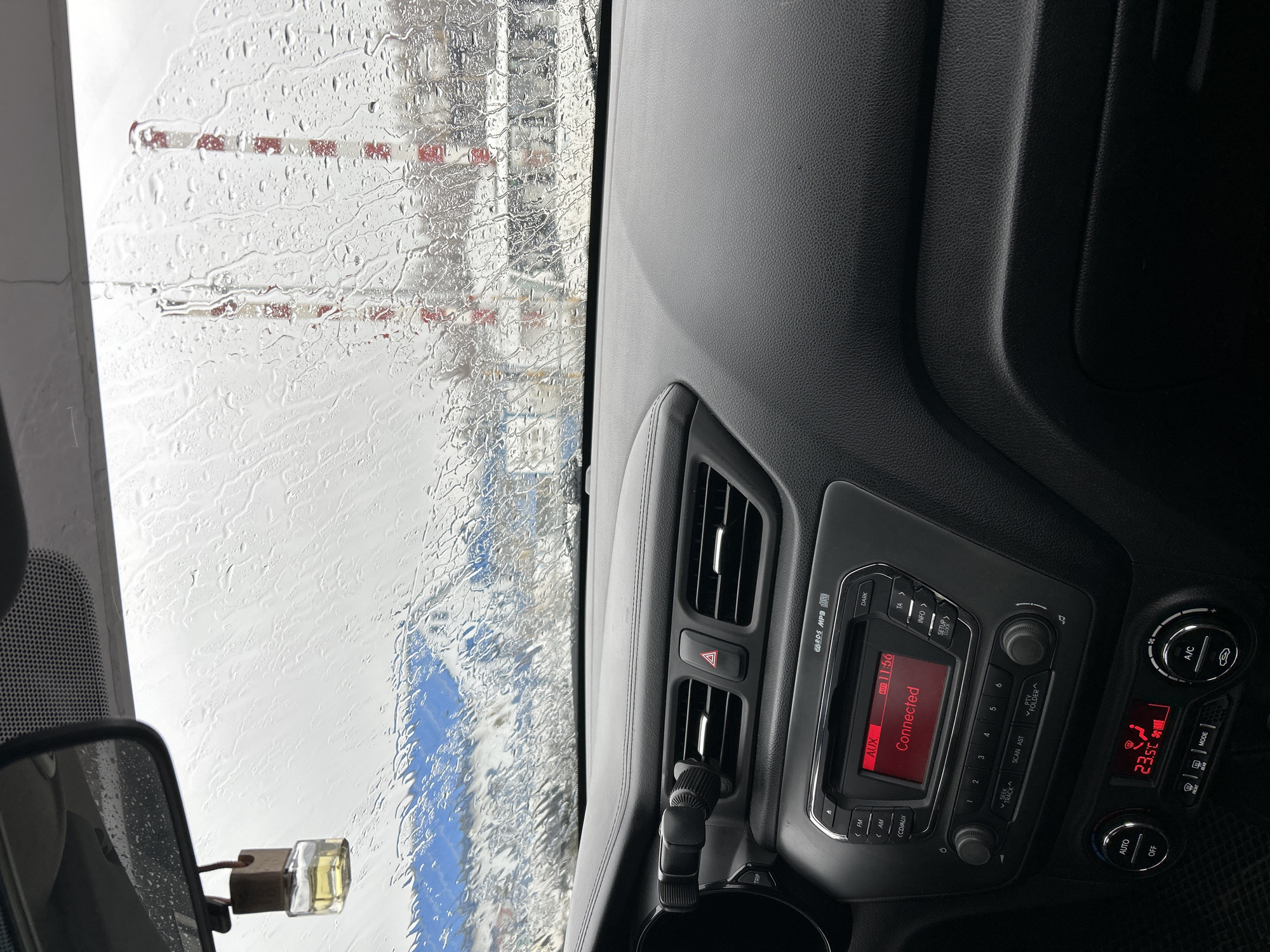 Driver waits in car during rain in Ural'skoe