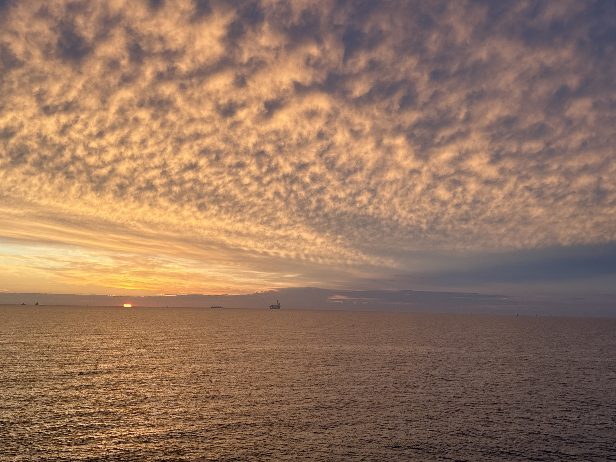Dramatic cloud formations observed over seascape at sunset