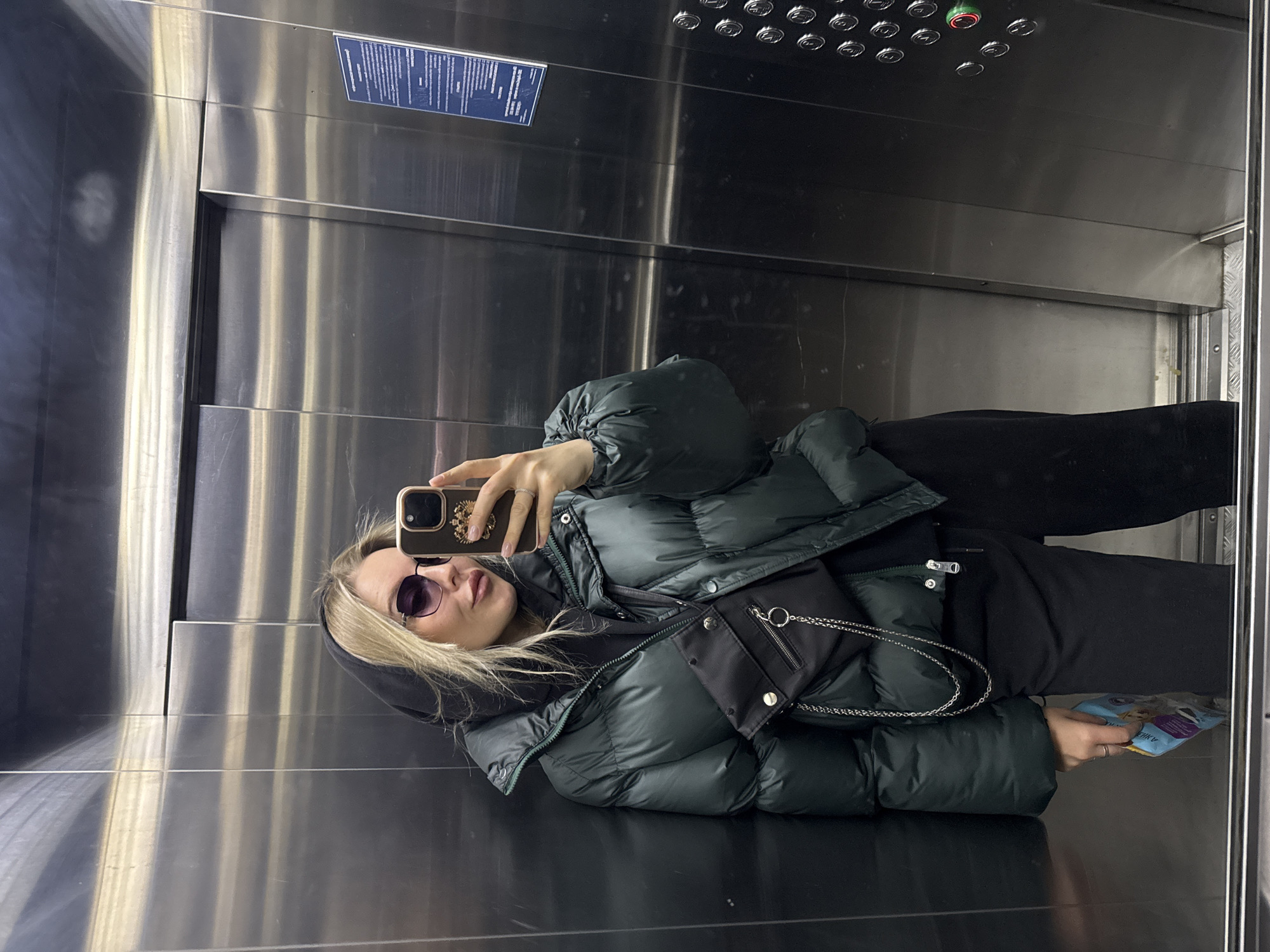Woman takes selfie in elevator in Krasnoyarsk, Russia