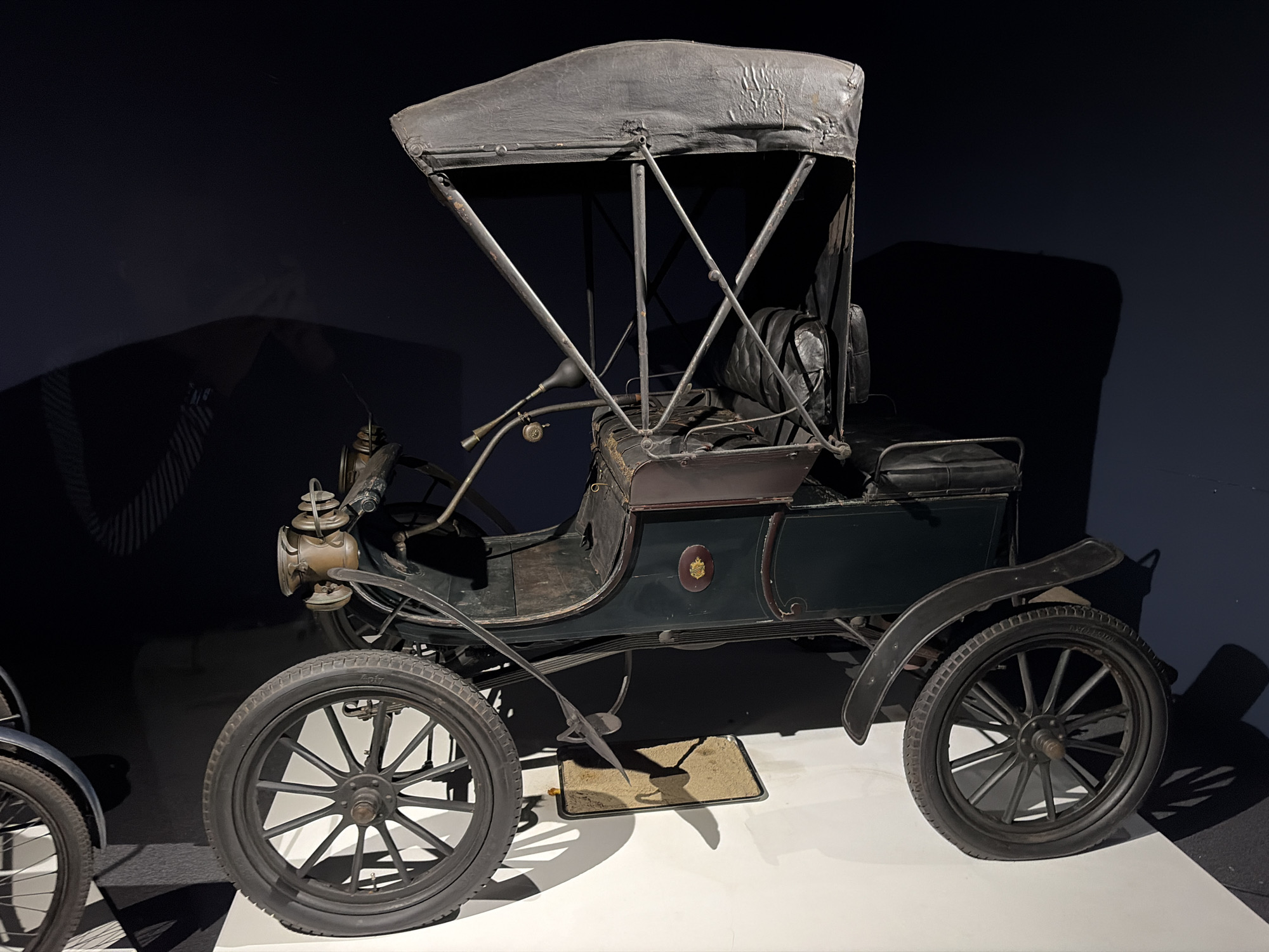Vintage vehicle collection displayed at museum exhibition hall