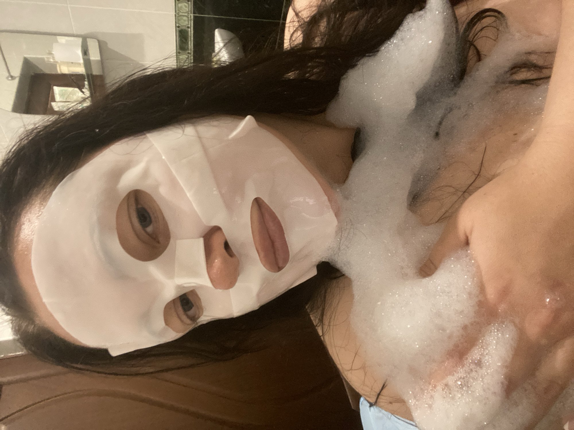 Person enjoys facial mask during bubble bath in Sochi