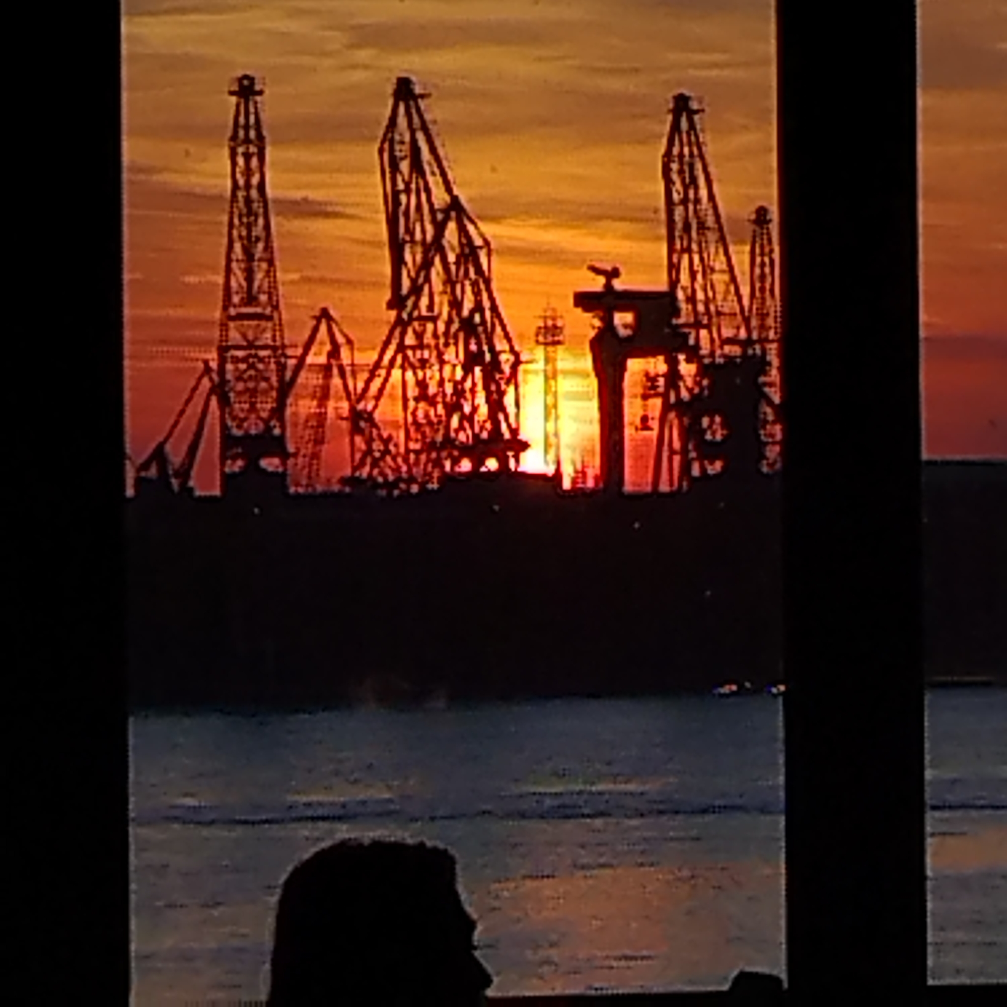 Sunset captures Varna port industrial silhouettes against fiery sky