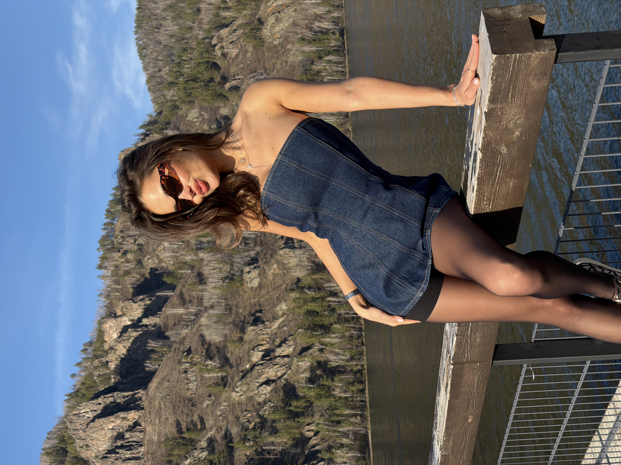 Woman poses on waterfront pier in Divnogorsk, Russia