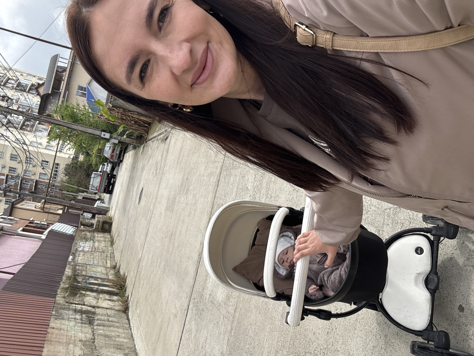 Mother with baby and dog takes morning stroll through Sochi