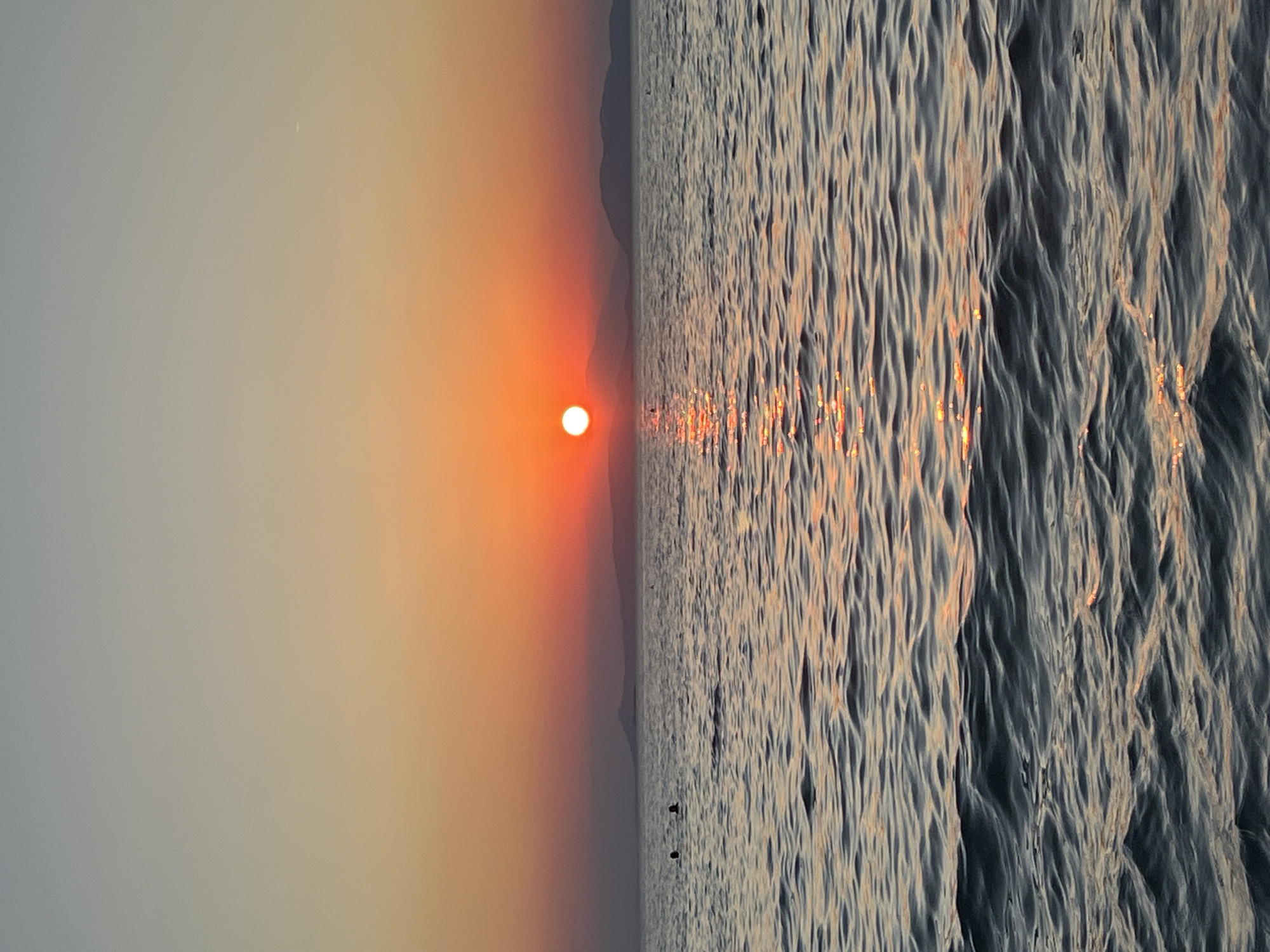 Sunset hour at a packed Vouliagmeni beach, Aegean coast