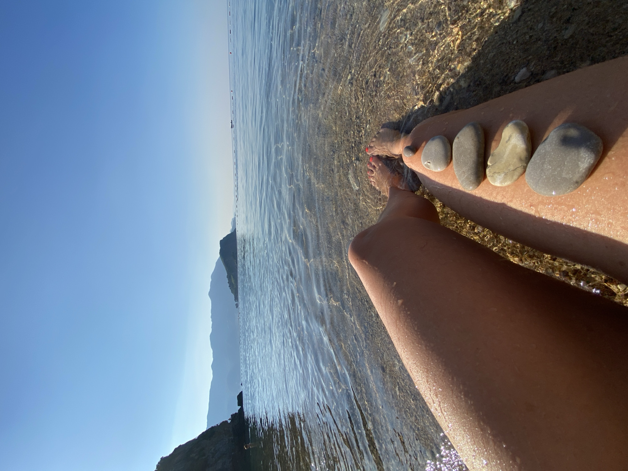 A slow morning along the Budva waterfront, beach to clifftops.