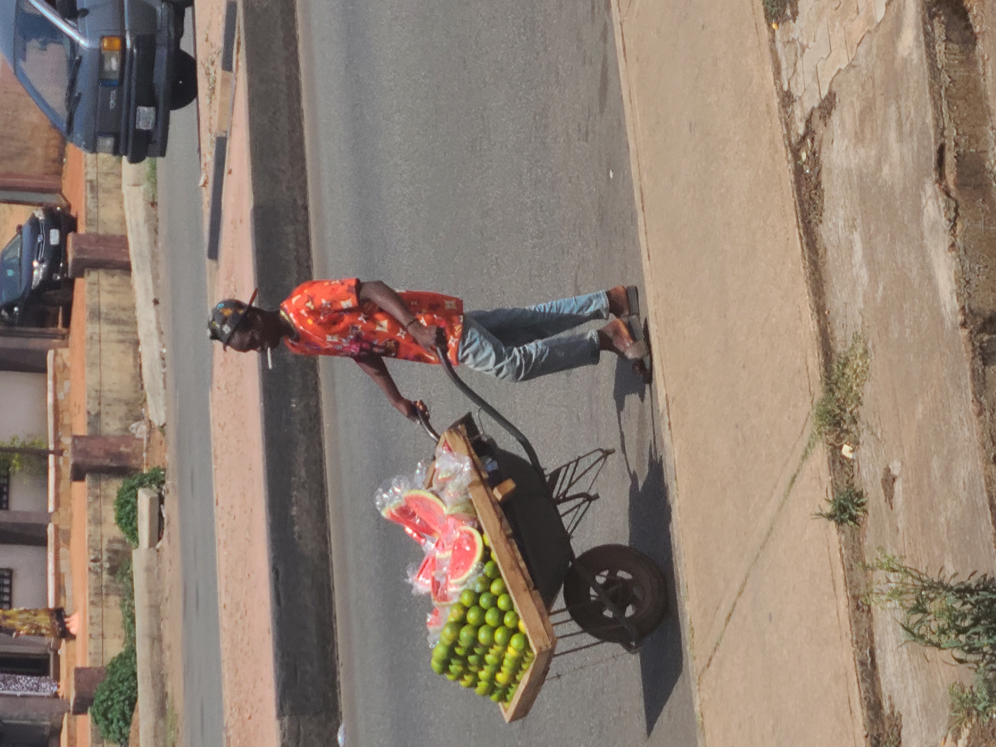 Daily life unfolds across sunny Jos streets
