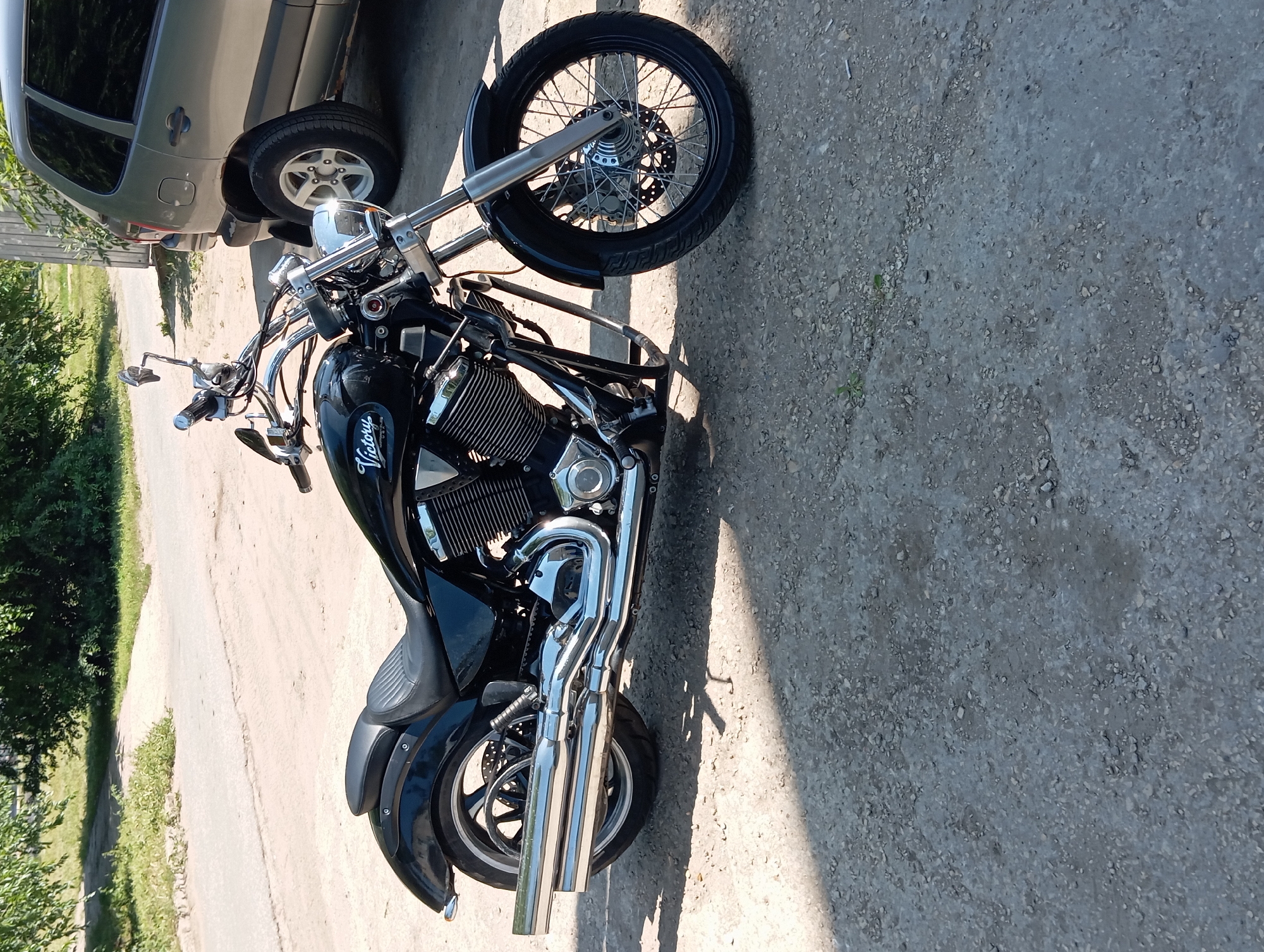 Black Victory motorcycle parked on gravel in Balakovo
